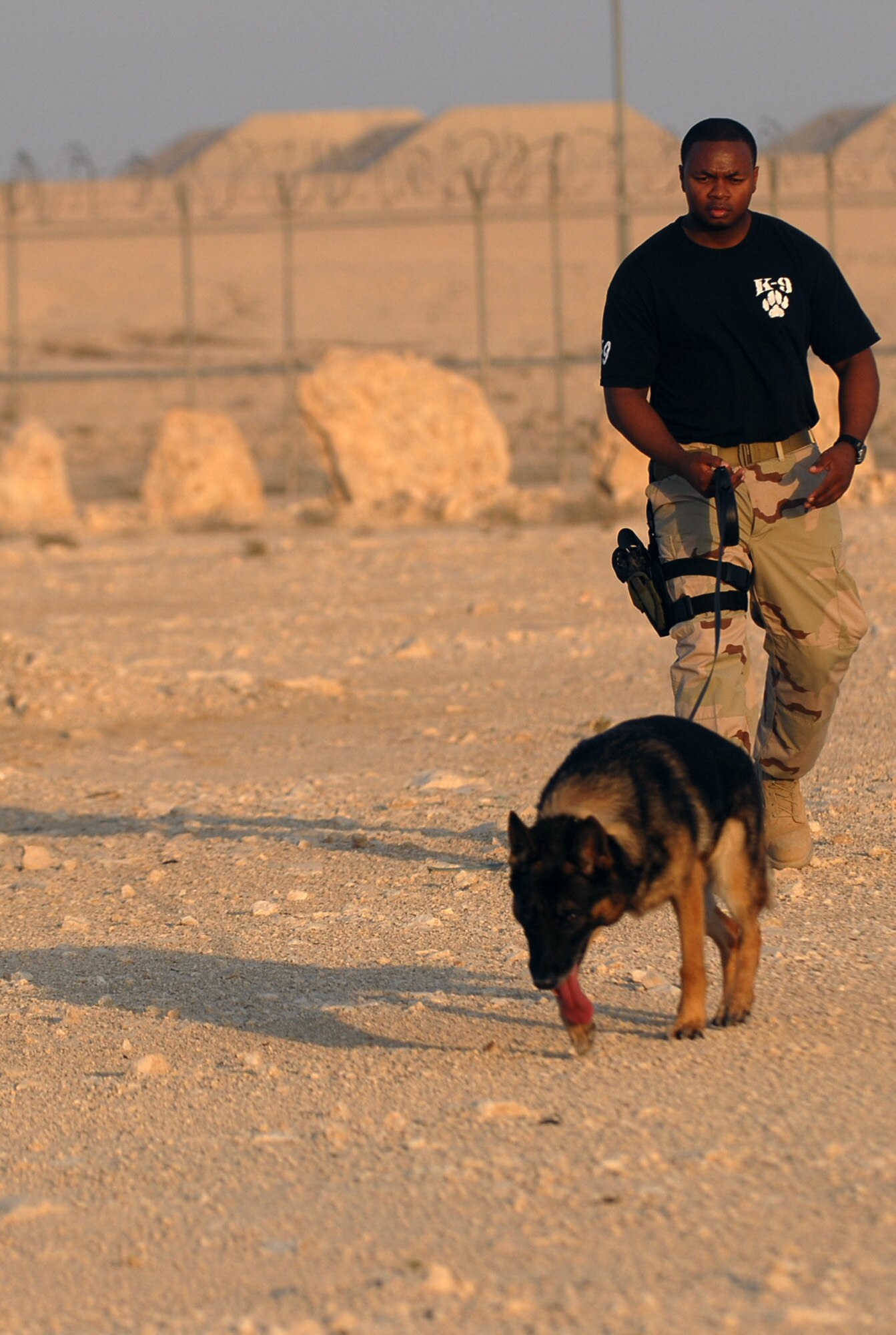 SOUTHWEST ASIA - Senior Airman Travell Bice and his K9 partner, Beki, work a training course Nov. 14 at a Southwest Asia air base. Airman Bice is deployed from Seymour Johnson AFB, N.C. His partner, Beki, is six years old.  (U.S. Air Force photo/Staff Sgt. Douglas Olsen)