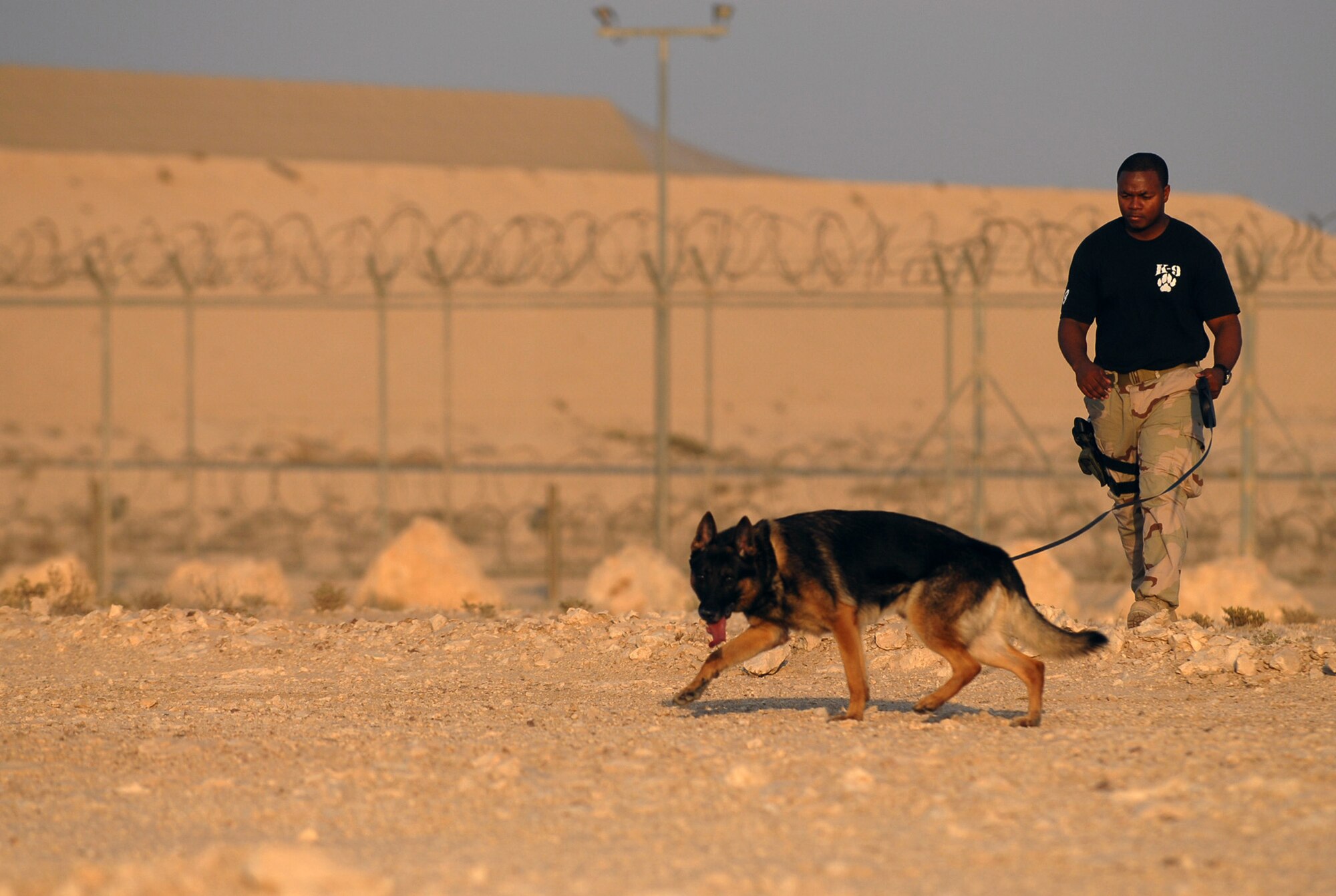 SOUTHWEST ASIA - Senior Airman Travell Bice and his K9 partner, Beki, work a training course Nov. 14 at a Southwest Asia air base. Airman Bice is deployed from Seymour Johnson AFB, N.C. His partner, Beki, is six years old.  (U.S. Air Force photo /Staff Sgt. Douglas Olsen)