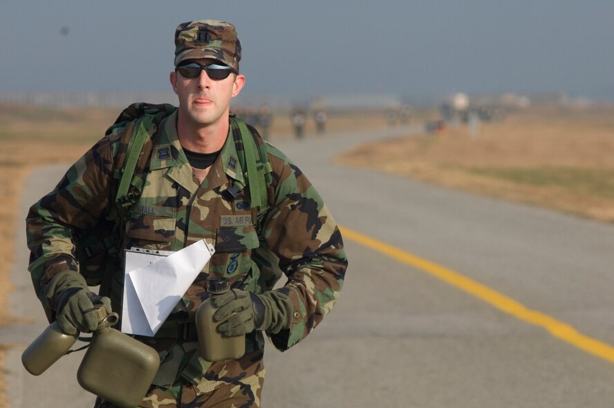 KUNSAN AIR BASE, South Korea--  As a strategy to keep his team moving, Capt. Lucas Hall from the 8th Security Forces Squadron, runs ahead of his teammates to begin filling their canteens at a mandatory water checkpoint during the 1st Annual Veterans Day Memorial Ruck/Run held here Nov. 17.  Ten teams comprised of four members participated in a 10K march carrying 40 pound ruck sacks followed by a 1.5 mile run. Teams from the Republic of Korea Air Force joined U.S. teams from Kunsan and Osan Air Bases for the competition in an effort to build teamwork and camaraderie.  (U.S. Air Force Photo/Master Sgt. Jack Braden)
