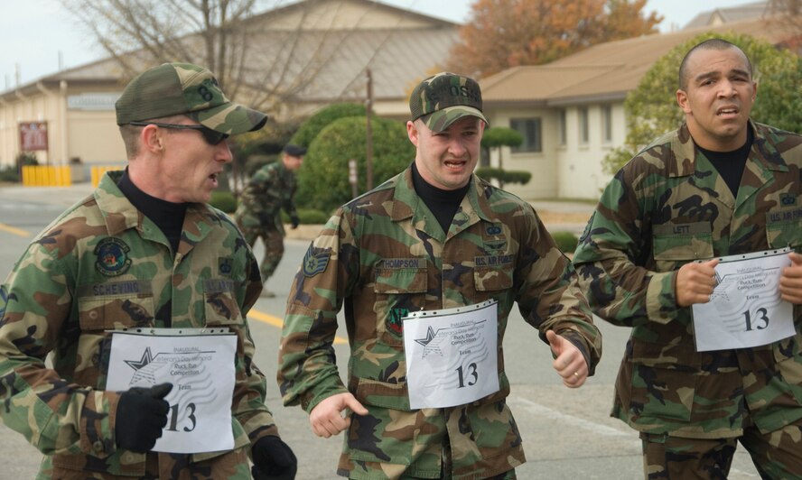 KUNSAN AIR BASE, South Korea--  Master Sgt. Tom Scheving, left, motivates his team mates, Staff Sgt. Jack Thompson and Staff Sgt. Ken Lett, as they approach the finish line of the 1st Annual Veterans Day Memorial Ruck/Run held here Nov. 17.  Ten teams comprised of four members participated in a 10K march carrying 40- pound ruck sacks followed by a 1.5 mile run. Sergeant Scheving and his team are assigned to the 8th Operations Squadron.Teams from the Republic of Korea Air Force joined U.S. teams from Kunsan and Osan Air Bases for the competition in an effort to build teamwork and camaraderie.  (U.S. Air Force Photo/Master Sgt. Jack Braden)
