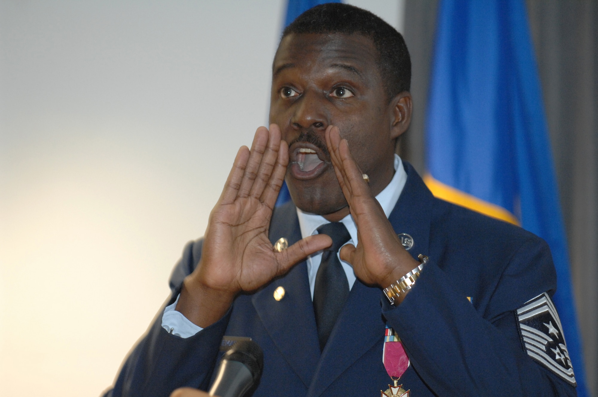 USAFE Command Chief Master Sergeant Gary G. Coleman reenacts an episode from his early years in the Air Force as the audience roared with laughter during his retirement ceremony at the Kisling Non-commisioned Officer Academy auditorium at Kapaun Air Station, Germany honoring him for 30 years of military service.  The chief’s retirement is effective May 1, 2008. (U.S. Air Force photo by Tech Sgt. Corey Clements)