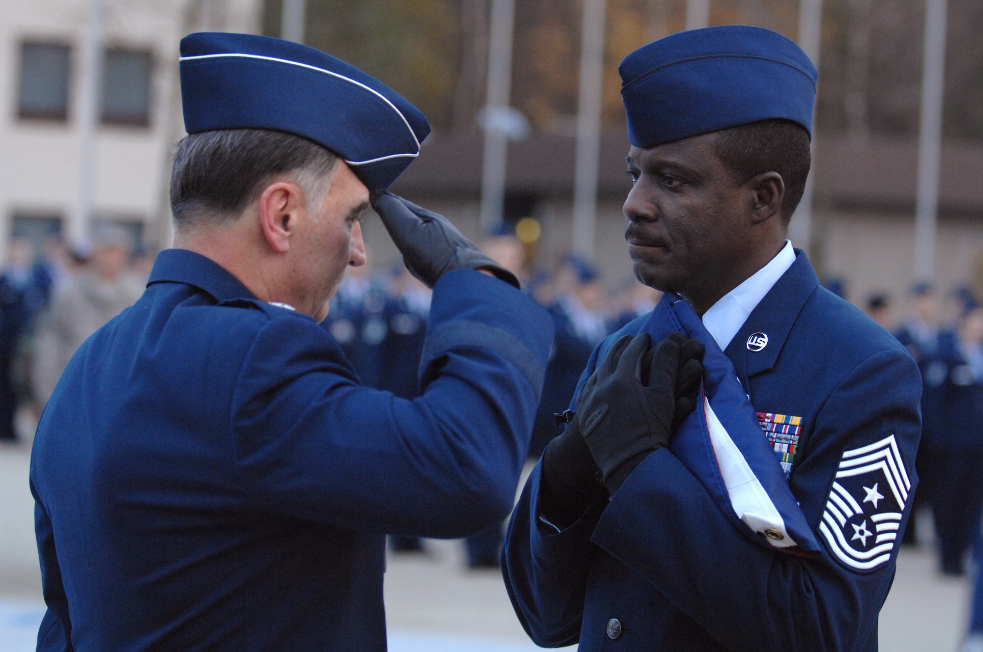 U.S. Air Forces in Europe Commander Gen William T. Hobbins salutes the flag after presenting it to USAFE Command Chief Master Sergeant Gary G. Coleman during a retreat ceremony.  The retreat ceremony followed a retirement ceremony honoring Chief Coleman for 30 years of military service.  The chief’s retirement is effective May 1, 2008. (U.S. Air Force photo by Tech Sgt. Corey Clements)
