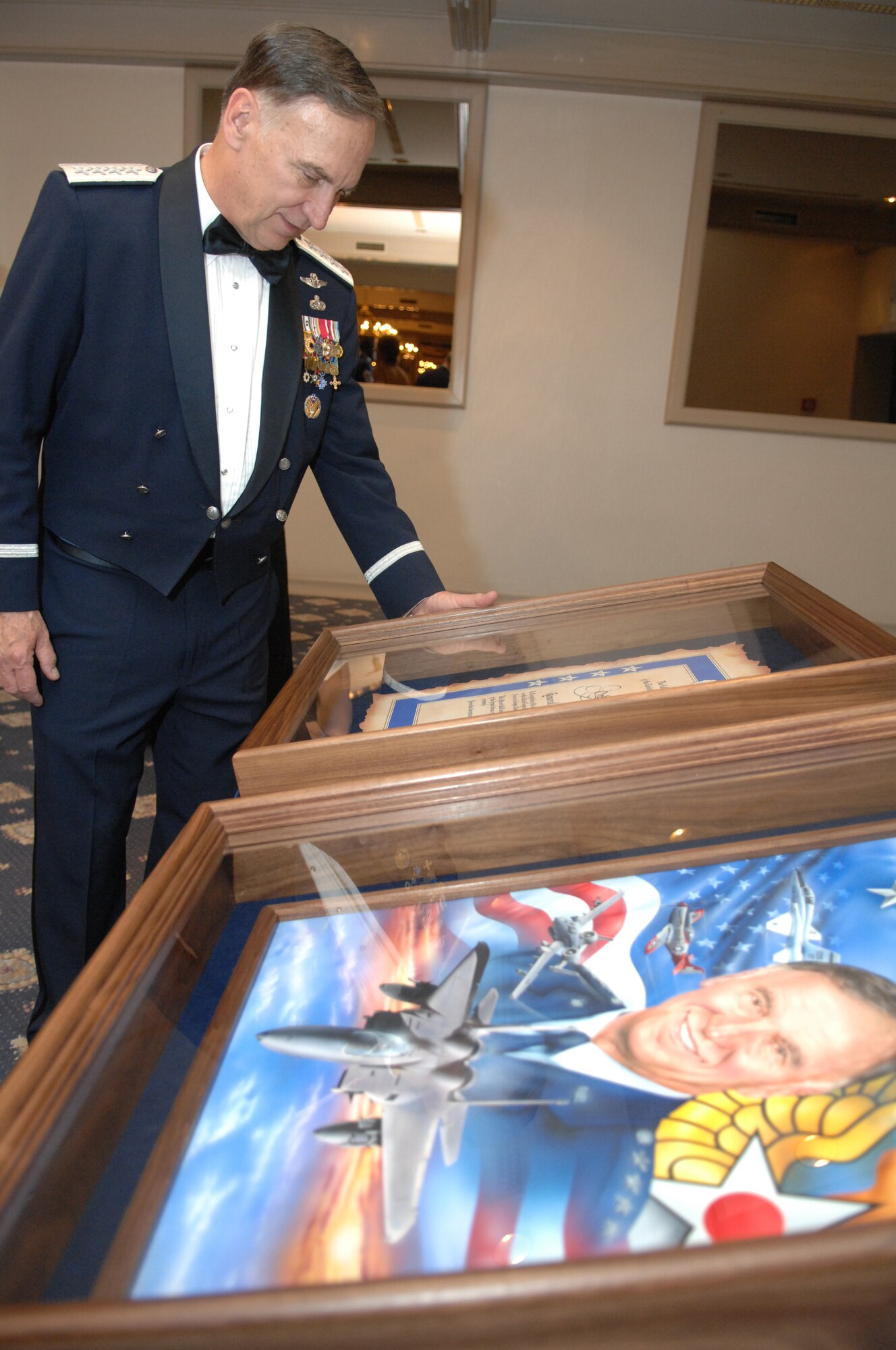 U.S. Air Forces in Europe Commander, General William T. Hobbins, admires some of the gifts he received during a USAFE order of the sword induction ceremony in his honor. The order of the sword induction is the highest honor the enlisted corps can bestow on an individual. (U.S. Air Force photo by Tech Sgt. Corey Clements)