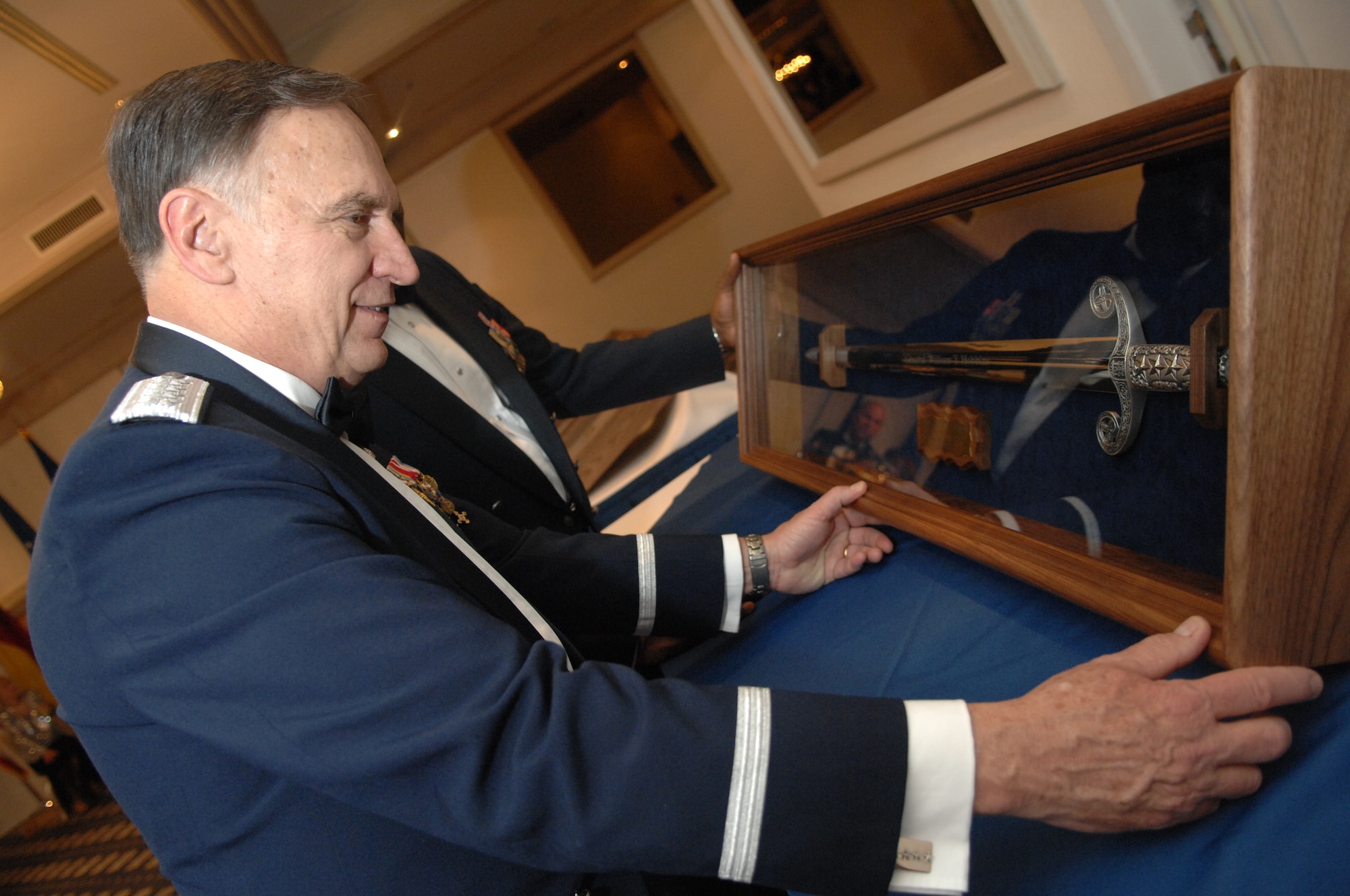 U.S. Air Forces in Europe Commander, General William T. Hobbins, admires a sword he received during a USAFE order of the sword induction ceremony in his honor.  The sword represents truth, justice, and rightfully used power and induction into the order is the highest honor an enlisted organization or command can bestow on an individual. (U.S. Air Force photo by Tech Sgt. Corey Clements)