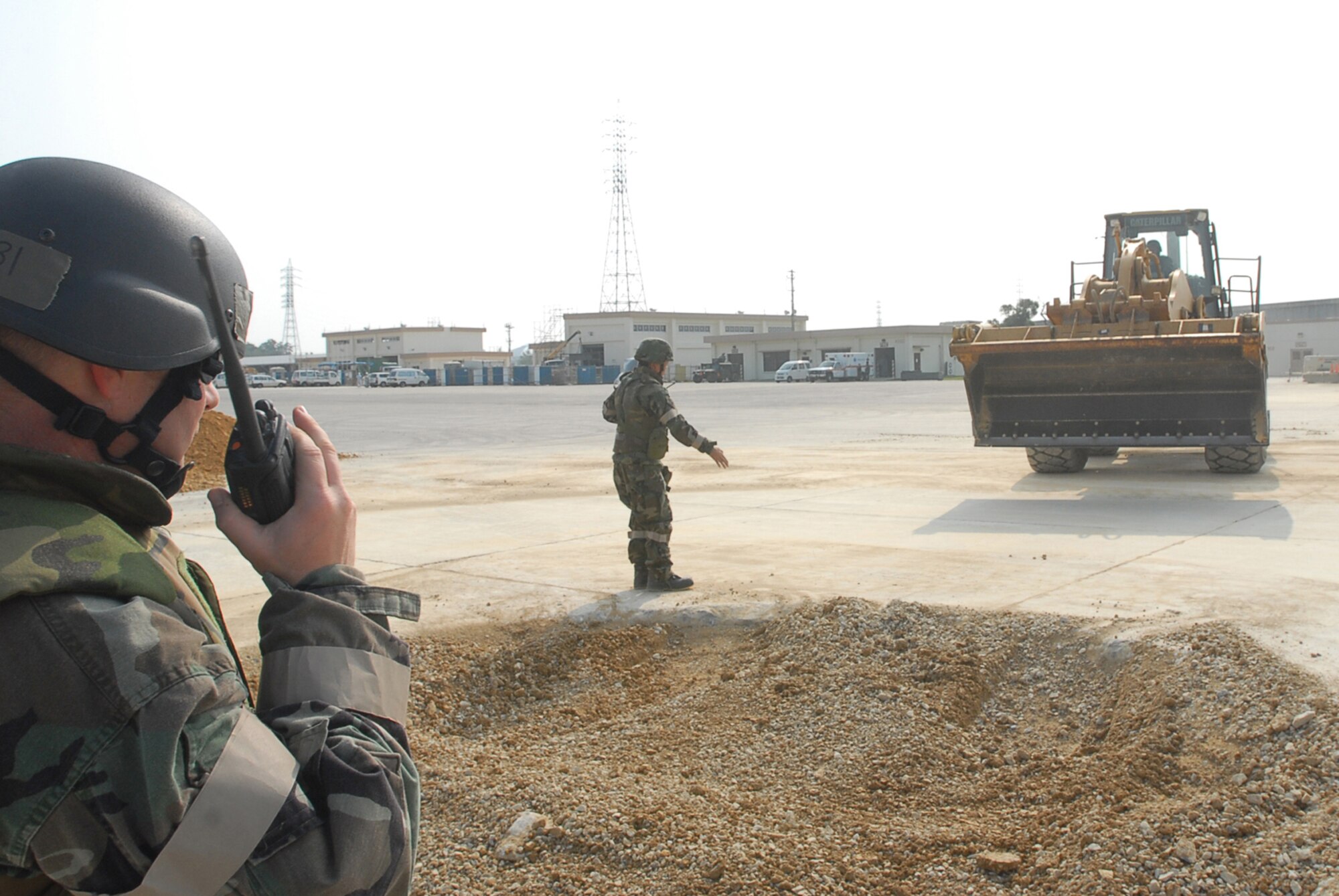 Tech. Sgt. Tony Aquilano, 36th Civil Engineer Squadron, radios the control center about the progress of repairing the holes in an airfield in the training area Nov. 16, 2007, at Kadena Air Base, Japan. Approximately 110 personnel, most from Andersen Air Force Base, Guam, attended the Det. 1, 554th Rapid Engineer Deployable Heavy Operational Repair Squadron Engineer Silver Flag exercise here. (U.S. Air Force photo/Senior Airman Darnell T. Cannady)