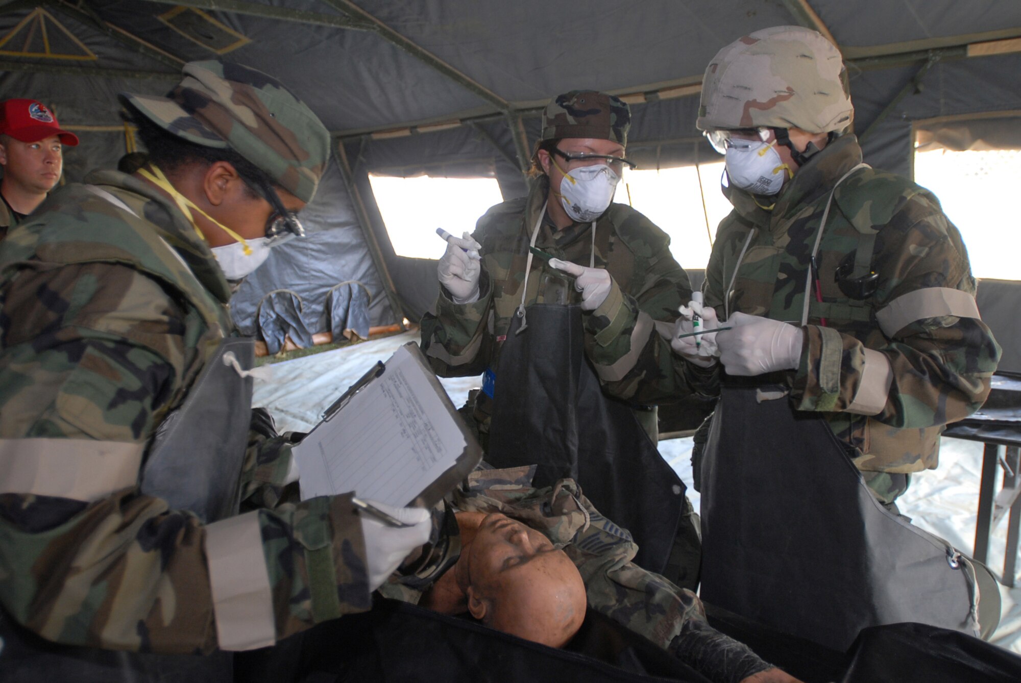 Airman 1st Class Connecticut Wilson (left), Staff Sgt. Joanne Richards, and Airman 1st Class Darrin Wagner, 36th Services Squadron, process a simulated deceased person's information for the mortuary affairs portion of an exercise Nov. 16, 2007, at Kadena Air Base, Japan. Approximately 110 personnel, most from Andersen Air Force Base, Guam, attended the Det. 1, 554th Rapid Engineer Deployable Heavy Operational Repair Squadron Engineer Silver Flag exercise here. (U.S. Air Force photo/Senior Airman Darnell T. Cannady)