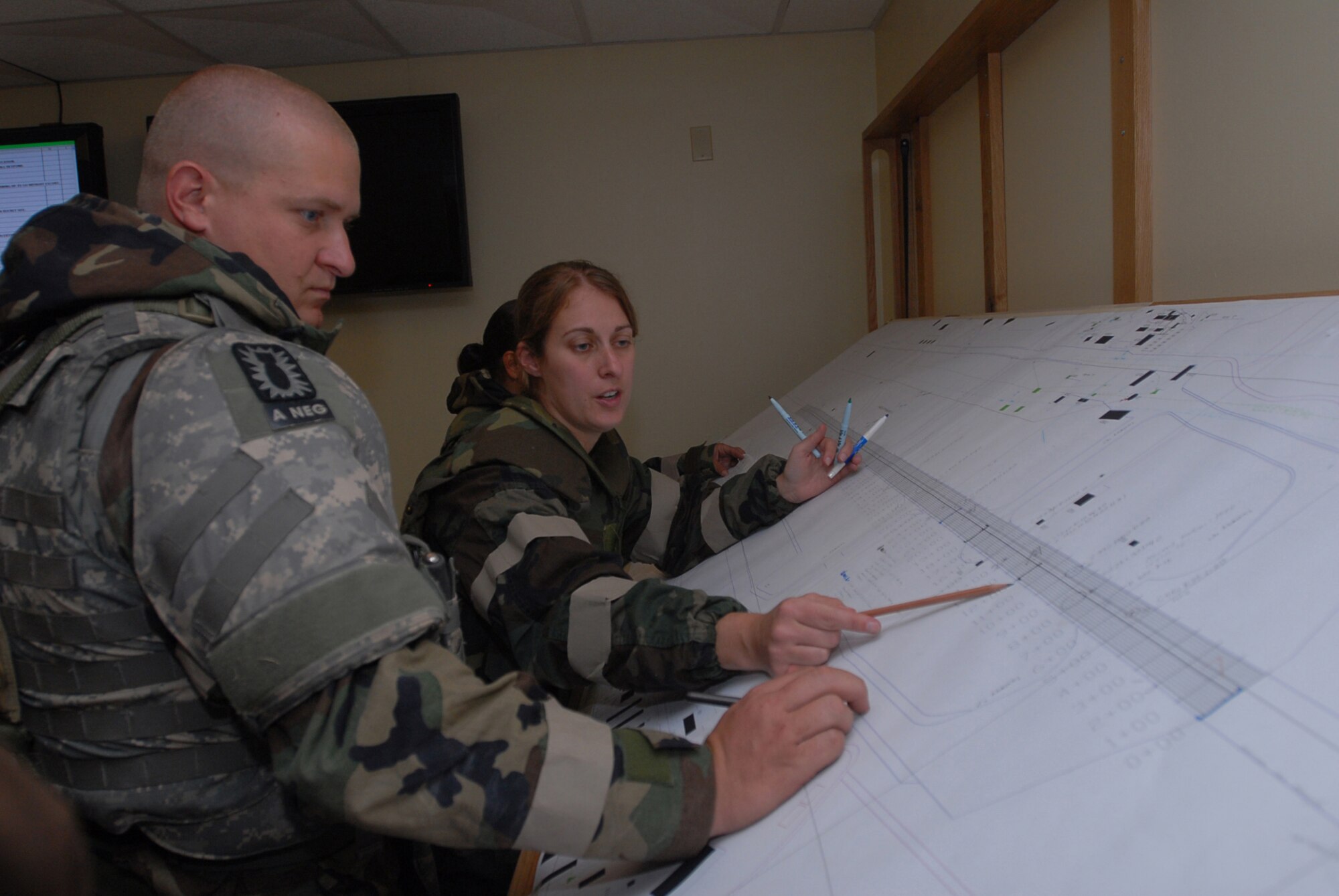 Staff Sgt. Rachael Bonafede and Tech. Sgt. Ronald White, 36th Civil Engineer Squadron, mark craters on the airfield map Nov. 16, 2007, at Kadena Air Base, Japan. Approximately 110 personnel, most from the 36th CES out of Andersen Air Force Base, Guam, attended the Det. 1, 554th Rapid Engineer Deployable Heavy Operational Repair Squadron Engineer Silver Flag exercise here. (U.S. Air Force photo/Senior Airman Darnell T. Cannady)