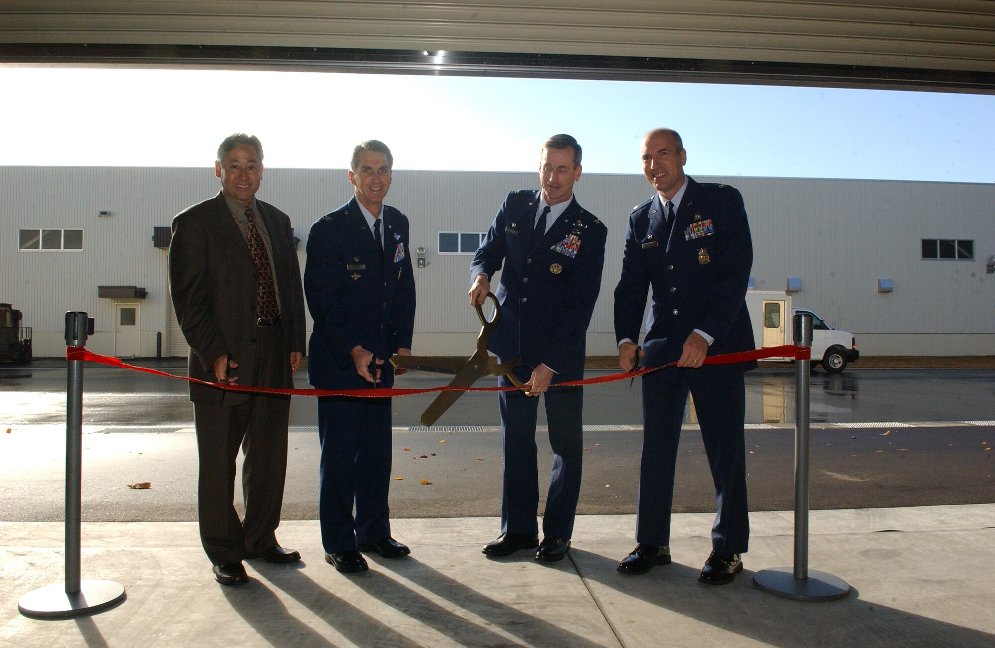 MISAWA AIR BASE, Japan -- Left to right: Gary Kitkowski, chief of the program and project management division at Camp Zama; Col. Mark Burns, 35th Mission Support Group commander; Col. T.J. O'Shaughnessy, 35th Fighter Wing commander; and Col. Joseph Marcinkevich, 35th Civil Engineer Squadron commander; formally announce the opening of the new 35th CES complex Nov. 13, 2007. (U.S. Air Force photo by Senior Airman Robert Barnett)