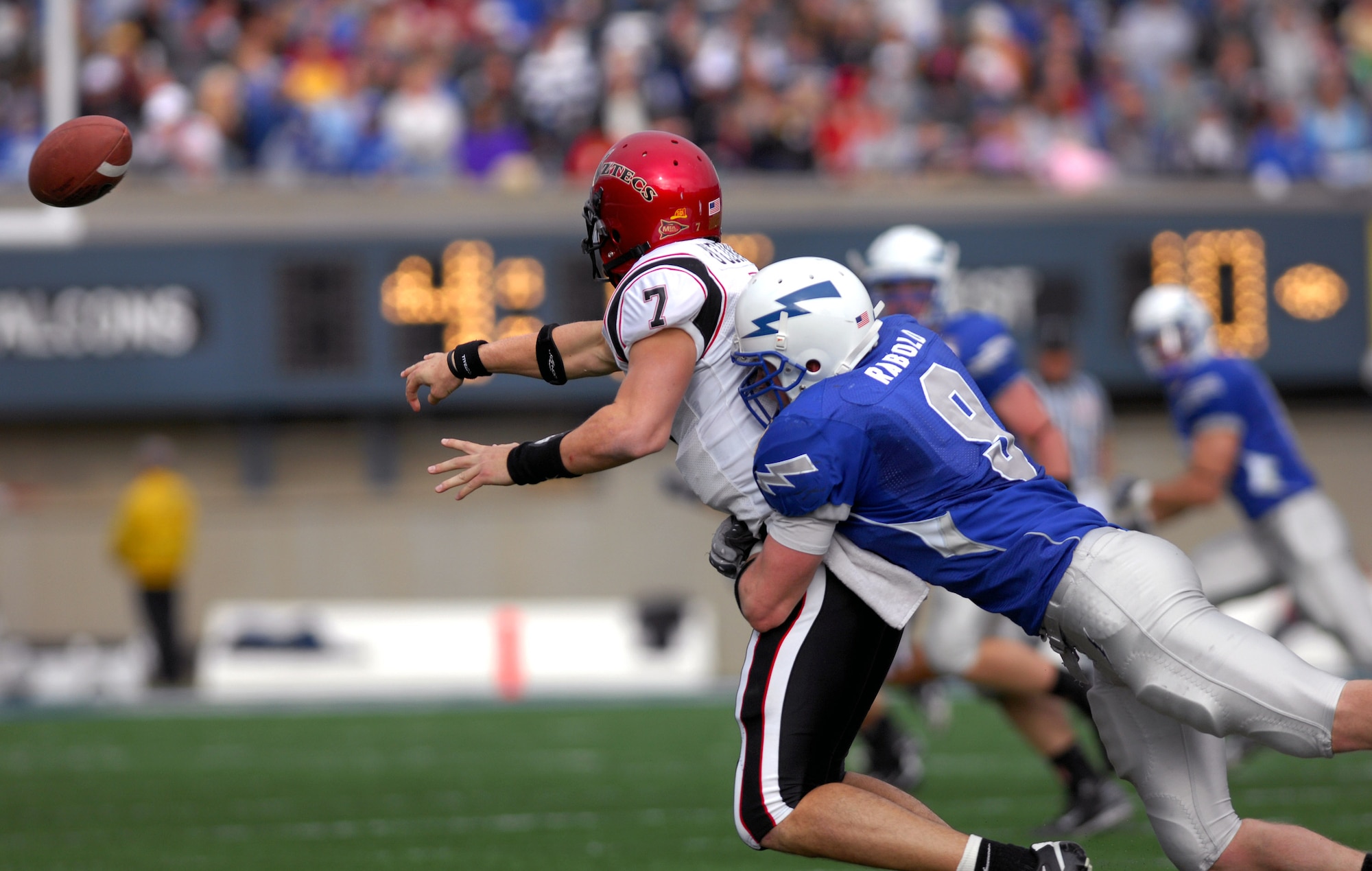 Falcon linebacker John Rabold wraps up San Diego State quarterback Kevin O'Connell as he pitches the ball during Air Force's 55-23 win over the Aztecs Nov. 17 at the Academy's Falcon Stadium. Rabold forced and recovered a fumble. (U. S. Air Force photo/Dave Armer) 