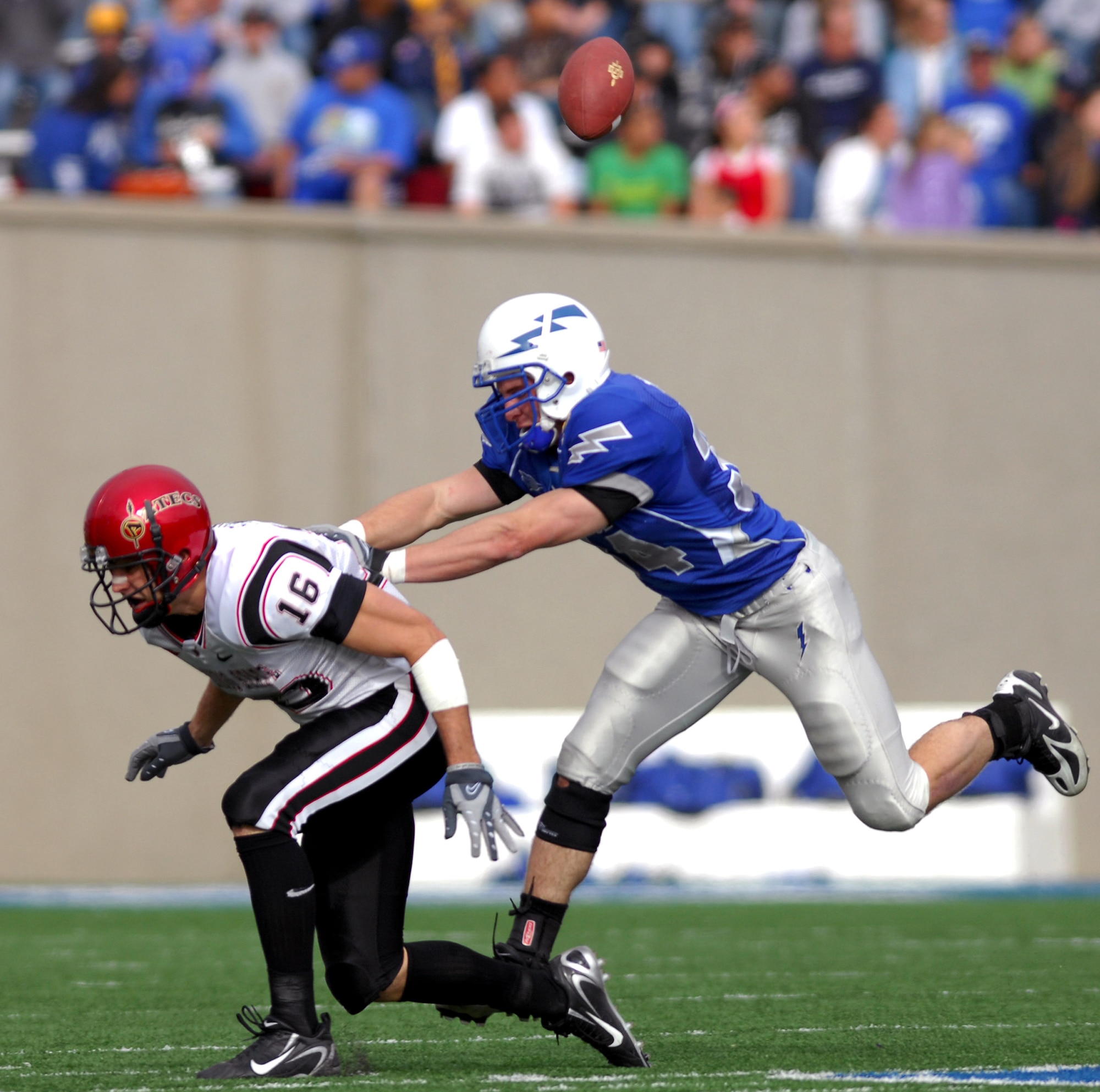 Falcon strong safety Chris Thomas jars the ball from San Diego State wide receiver Brett Swain during Air Force's 55-23 win over the Aztecs Nov. 17 at the Academy's Falcon Stadium. Thomas led the bluesuiter defense with 13 tackles, including six solos. (U. S. Air Force photo/Dave Armer) 
