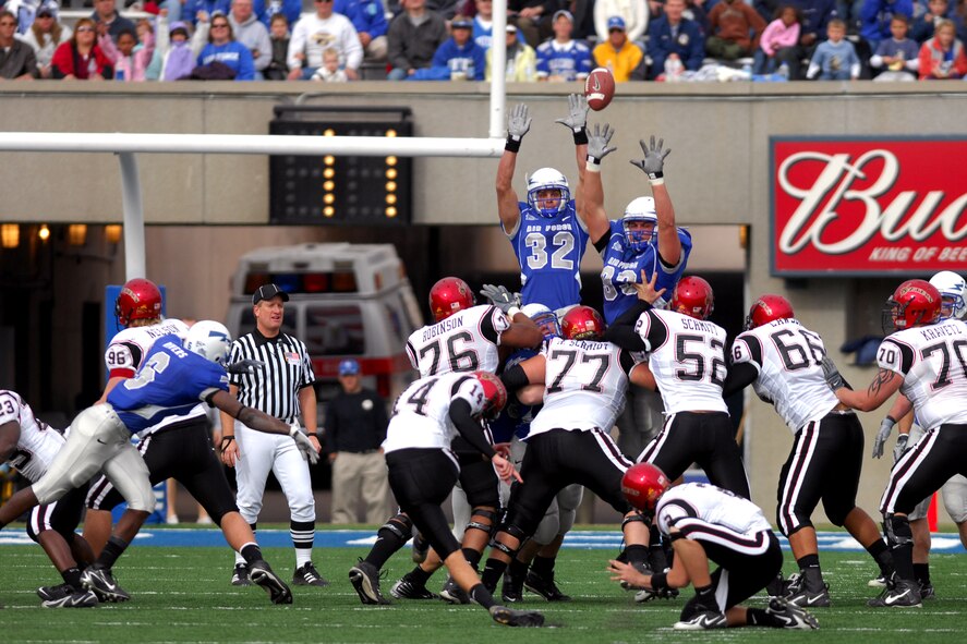 Falcon special team players Hunter Altman, 32, and Michael Krogh, 82, try to block a field goal attempt by San Diego State kicker Garrett Palmer, 14, during Air Force's 55-23 win over the Aztecs Nov. 17 at the Academy's Falcon Stadium. (U. S. Air Force photo/Dave Armer) 