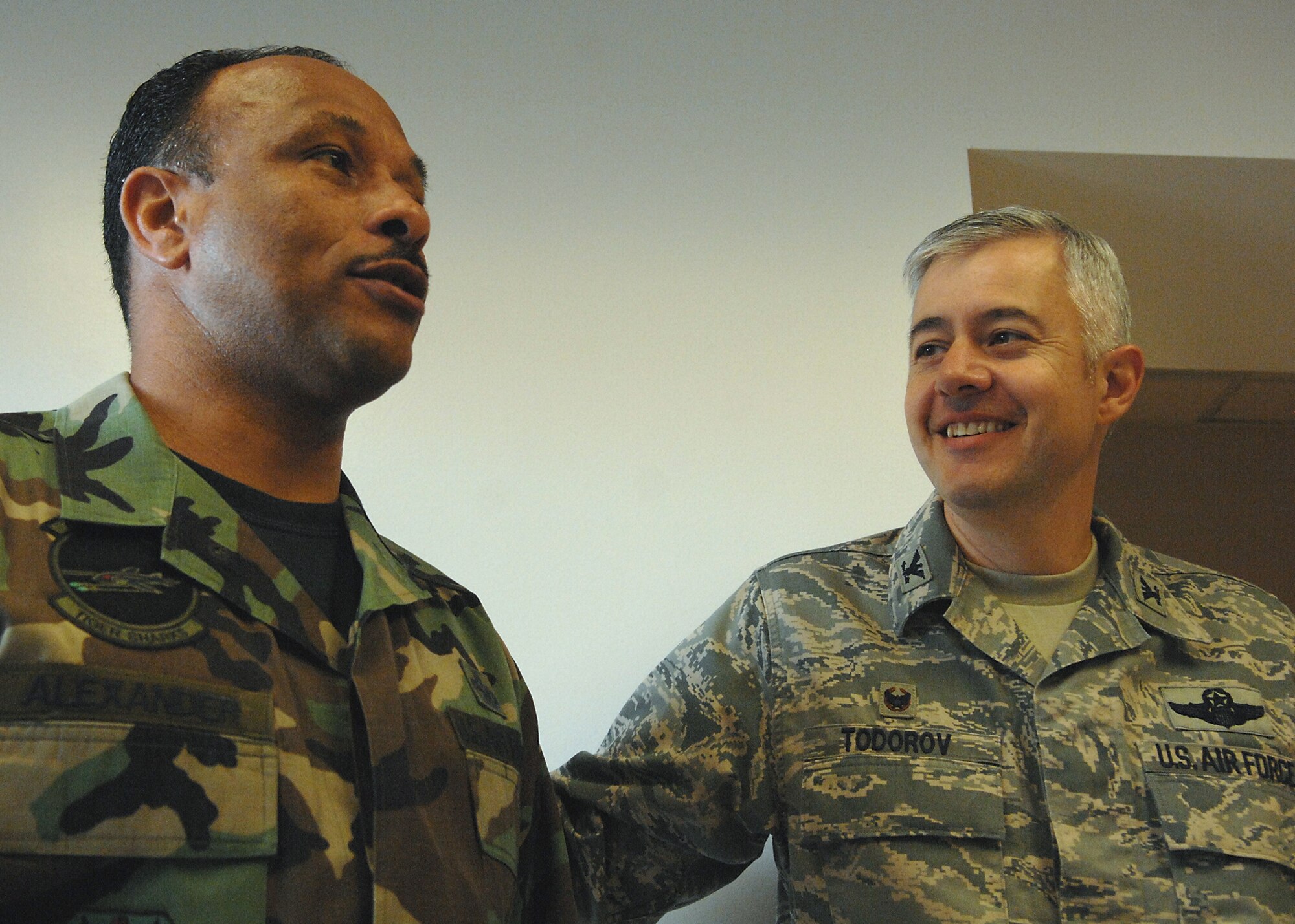Col. Kenneth Todorov, 23rd Wing Commander, speaks with a surprised Chief Master Sergeant (Select) Alejandro Alexander, moments after he was informed of his promotion. Chief select Alexander is assigned with the 23rd Aircraft Maintenance Squadron (U.S. Air Force photo by Airman 1st Class Brittany Barker)
