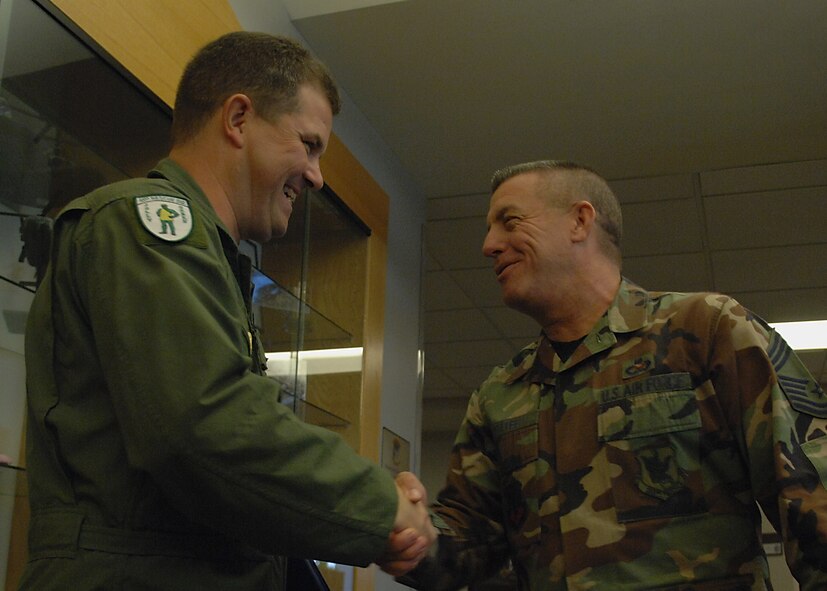 Chief Master Sergeant  Ronald McAtee, 23rd Maintenance Group chief enlisted manager, congratulates Chief Master Sgt. (Select) Michael Stone after his promotion selection Nov 14.  (U.S. Air Force photo by Airman 1st Class Brittany Barker)
