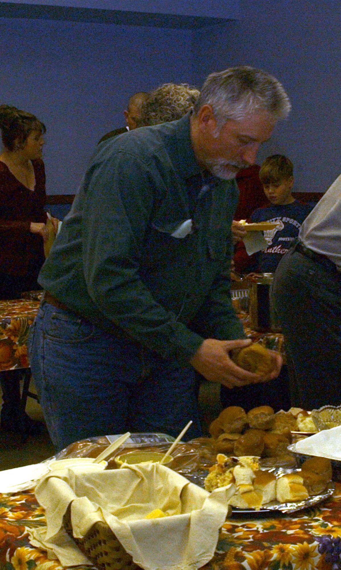 Mike Ezop, a Malmstrom retiree, gets a dinner roll from the buffet table at the community Thanksgiving dinner at the Chapel Annex Sunday. The annual holiday event is sponsored by the Catholic and Protestant communities. (U.S. Air Force photo/Valerie Mullett)