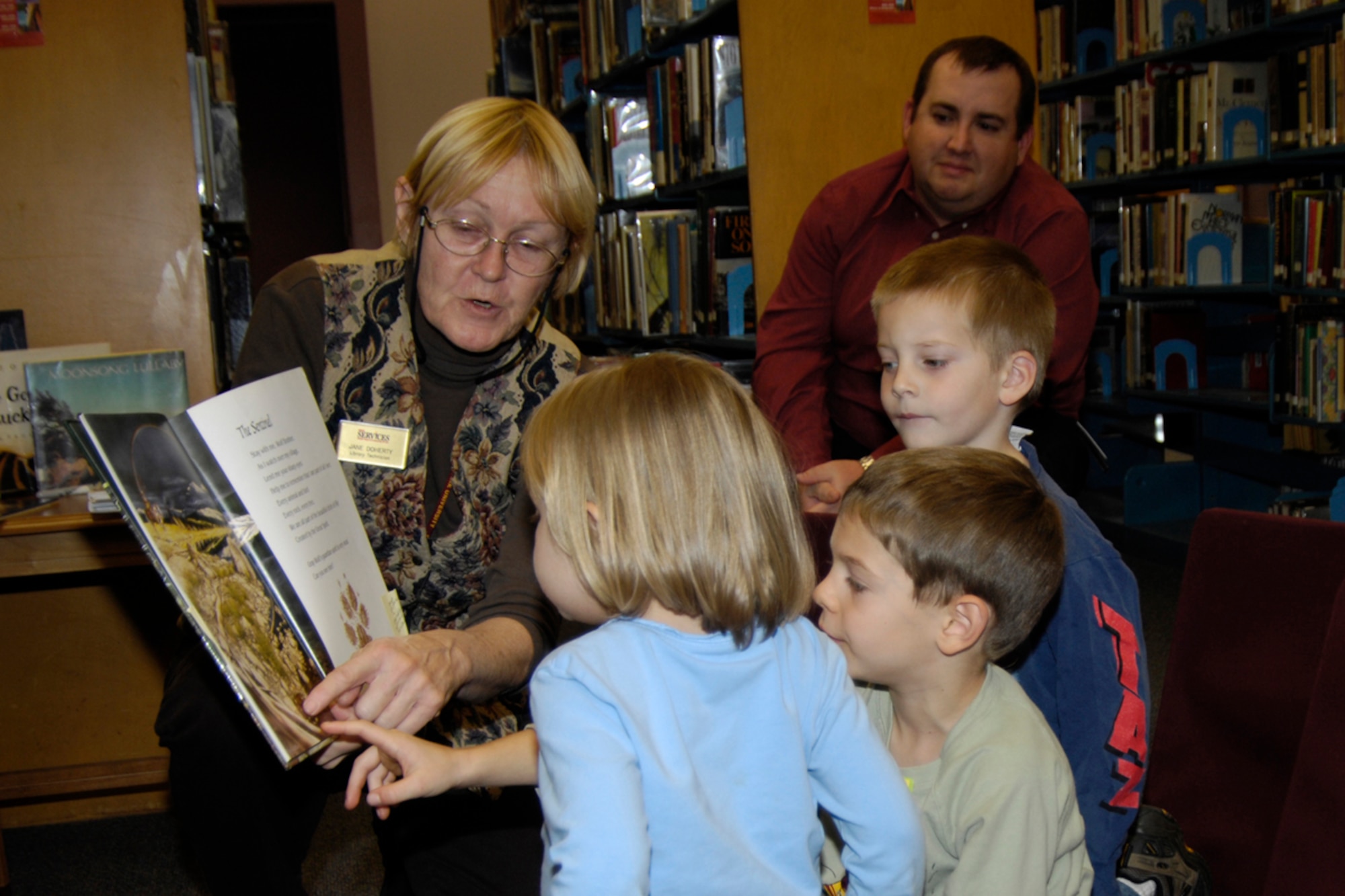 HANSCOM AIR FORCE Base -- Jane Doherty, Hanscom Library technician, reads the children’s book, “Brother Eagle, Sister Sky,” to Grace and Marshall Parish and Mitchell Wrisley during a Native American Story Telling session at the Base Library Nov. 14. The event was sponsored by the 551st Electronic Systems Wing to celebrate Native American Heritage Month, which is ongoing through November. On Nov. 28, “Indian Warriors – the Untold Story of the Civil War,” will be shown at the Base Theater at 11 a.m. For information on this event, contact Tom Arsenault at 781-377-8735. (U.S. Air Force photo by Linda LaBonte Britt)