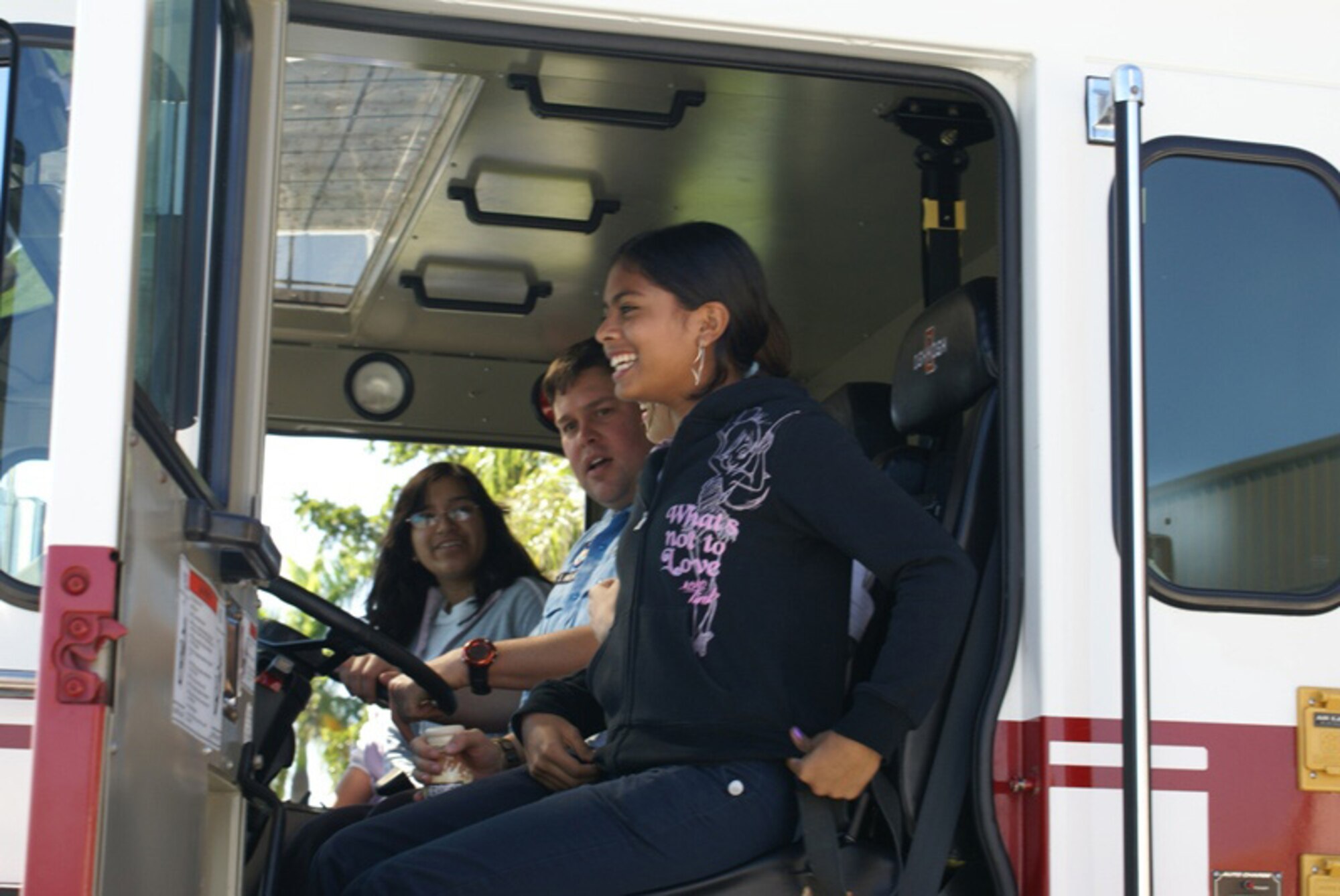 James Freece, 482nd Mission Support Group fire and emergency services technician, gives three Ruben Dario Middle School students an up close view of an Air Force fire-fighting vehicle during a tour of Homestead Air Reserve Base on Nov. 16. About 35 students met with pilots, security forces and fire and emergency services personnel during their visit. Homestead ARB offers two tours each month for students or community organizations. (U.S. Air Force photo/Senior Airman Erik Hofmeyer)