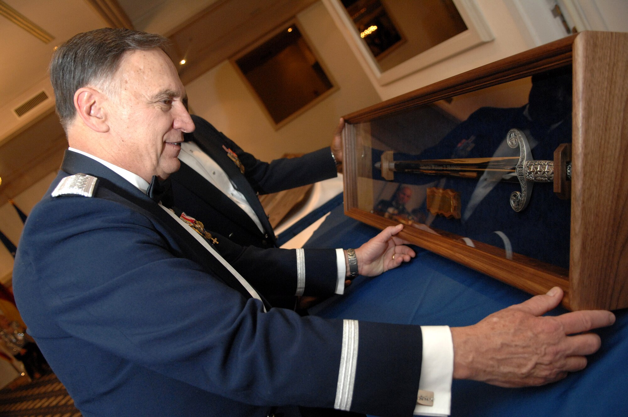 Gen. William T. Hobbins, U.S. Air Forces in Europe commander, admires the sword he received during a USAFE Order of the Sword induction ceremony in his honor. Being inducted into the order is the highest honor an enlisted organization or command can bestow on an individual. (U.S. Air Force photo/Tech Sgt. Corey Clements)
