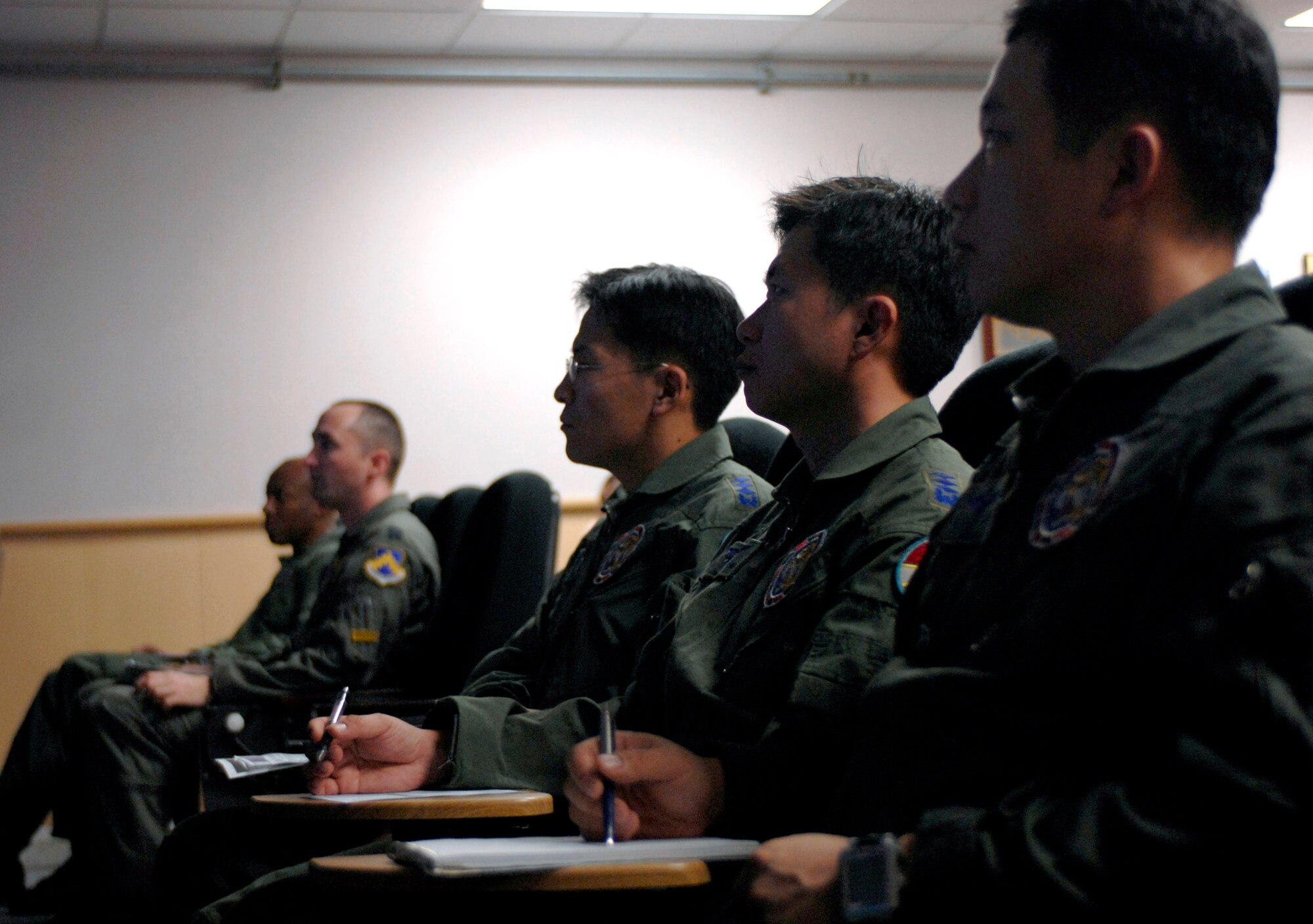 Pilots from the Republic of Korea Air Force, 111th Fighter Squadron along with pilots from the 8th Fighter Wing received a mission brief here Nov. 14. ROKAF pilots and Wolf Pack pilots trained together on a joint mission to give pilots from both countries a chance to work together and hone their warfighting skills. (U.S. Air Force photo/Staff Sgt. Araceli Alarcon)