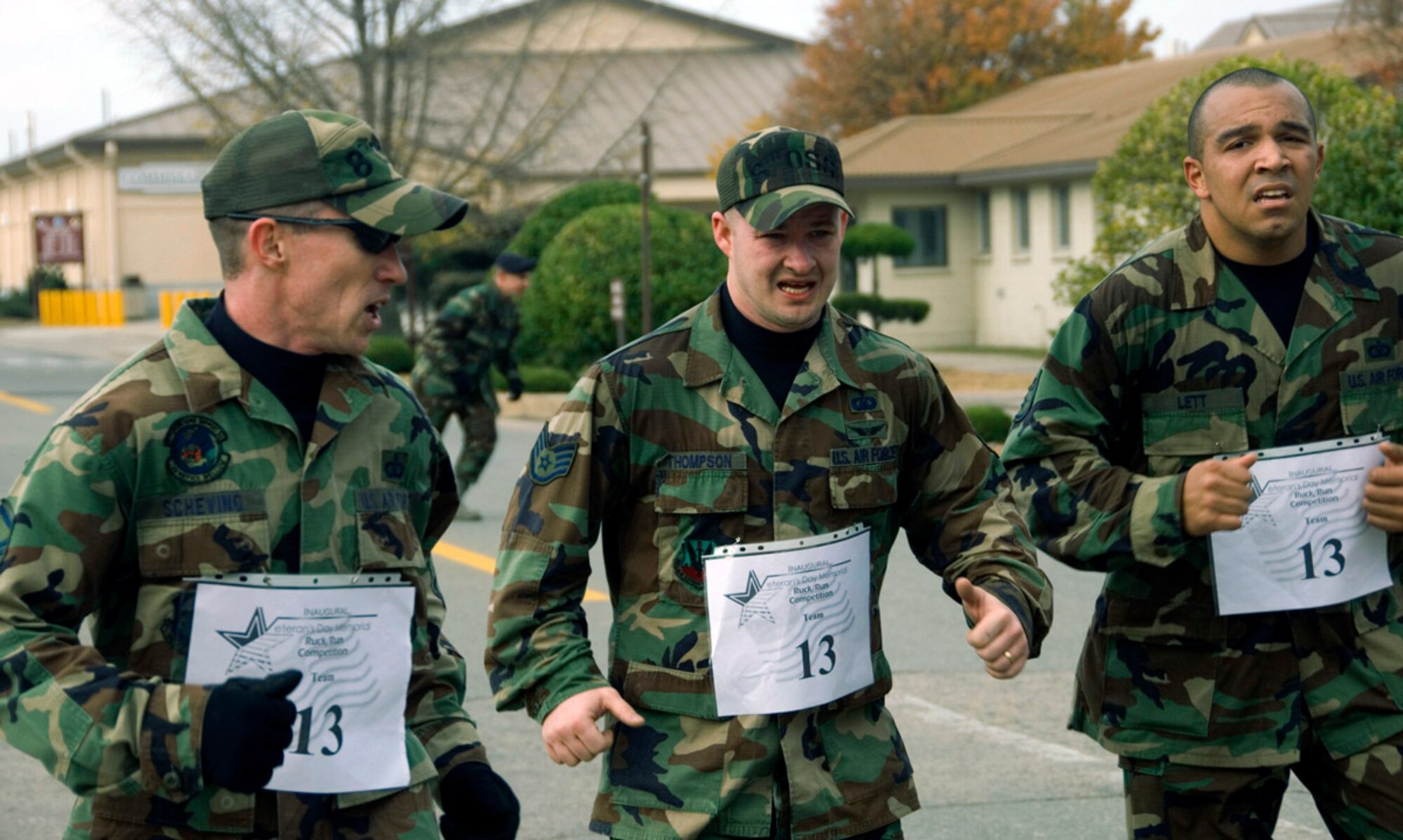 Master Sgt. Tom Scheving (left) motivates his teammates, Staff Sgts. Jack Thompson and Ken Lett, as they approach the finish line of the first Veterans Day Memorial Ruck/Run held Nov. 17 at Kunsan Air Base, Republic of Korea. Ten teams, each comprising four members, participated in a 10K march carrying 40-pound ruck sacks followed by a 1.5 mile run. Sergeant Scheving and his team are assigned to the 8th Operations Squadron.Teams from the Republic of Korea air force joined U.S. teams from Kunsan and Osan air bases for the competition in an effort to build teamwork and camaraderie. (U.S. Air Force Photo/Master Sgt. Jack Braden) 