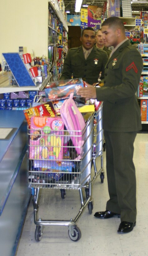 Marine Private First Class Jerico Berryhill-Colton, Marine Private First Class William Murphy and Marine Private First Class Seth Foresman, all students in the 364th Training Squadron's telecommunications course, loads up toys at Toys-R-Us Nov. 15 as part of the annual Toys-for-Tots drive. Drop off locations  for new toys in Wichita Falls include Expert Tire, the Marine recruiting station, Edward Jones Investing Kell West and Big Lots. For more information call Bob Kerr at 676-5227. (U.S. Air Force photo/Mike McKito)