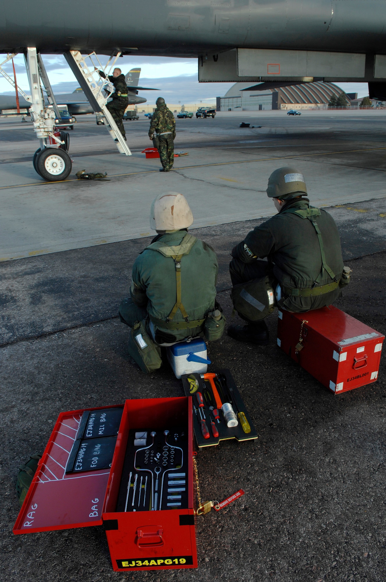 U.S. Air Force Senior Airman Courtney Armstrong (left), and Airman 1st Class Edward Kovalcin, both from the 28th Aircraft Maintenance Squadron, take a short break prior to having their B-1B Lancer inspected during Operational Readiness Inspection (ORI) Coronet White 07-ACC-12 at Ellsworth Air Force Base, S.D., Nov. 17, 2007.  An Air Combat Command inspection team will use this ORI to evaluate Ellsworth's ability to effectively and rapidly deploy.  (U.S. Air Force photo/Staff Sgt. Michael B. Keller)