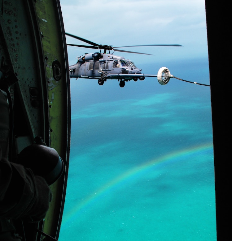 BIMINI, Bahamas --  A 920th Rescue Wing HH-60G Pave Hawk helicopter gets a fresh tank of gas during a recent search-and-rescue mission over Bimini, the small trio of islands that sit only 50 miles from Miami. The tanker doing the refueling was also a 920th asset, an HC-130P/N Hercules, which provided search-and-rescue support along with the fuel for the mission. (U.S. Air Force photo/Staff Sgt. Paul Flipse) 