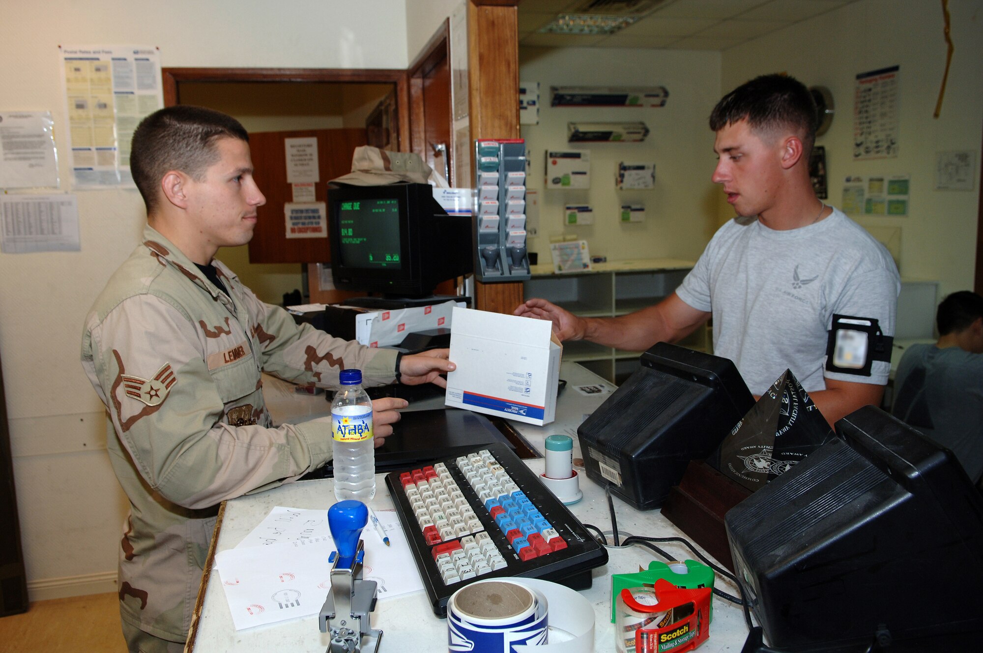 SOUTHWEST ASIA -As in previous wars, the mail is the life blood of good morale. This is especially true to deployed personnel like Airman 1st Class Jonathan Cavezza, 379th Expeditionary Security Forces Squadron. Airman Cavezza is deployed from Cheyenne Mountain AB, Colo. Senior Airman Steven Lemmer, 379th Ezxpeditionary Communications Squadron postal specialist, assists Airman Cavezza with mailing a package. Airman Lemmer is deployed from Vandenberg AFB, Calif.
(Air Force Photo/Master Sergeant Greg Kunkle)