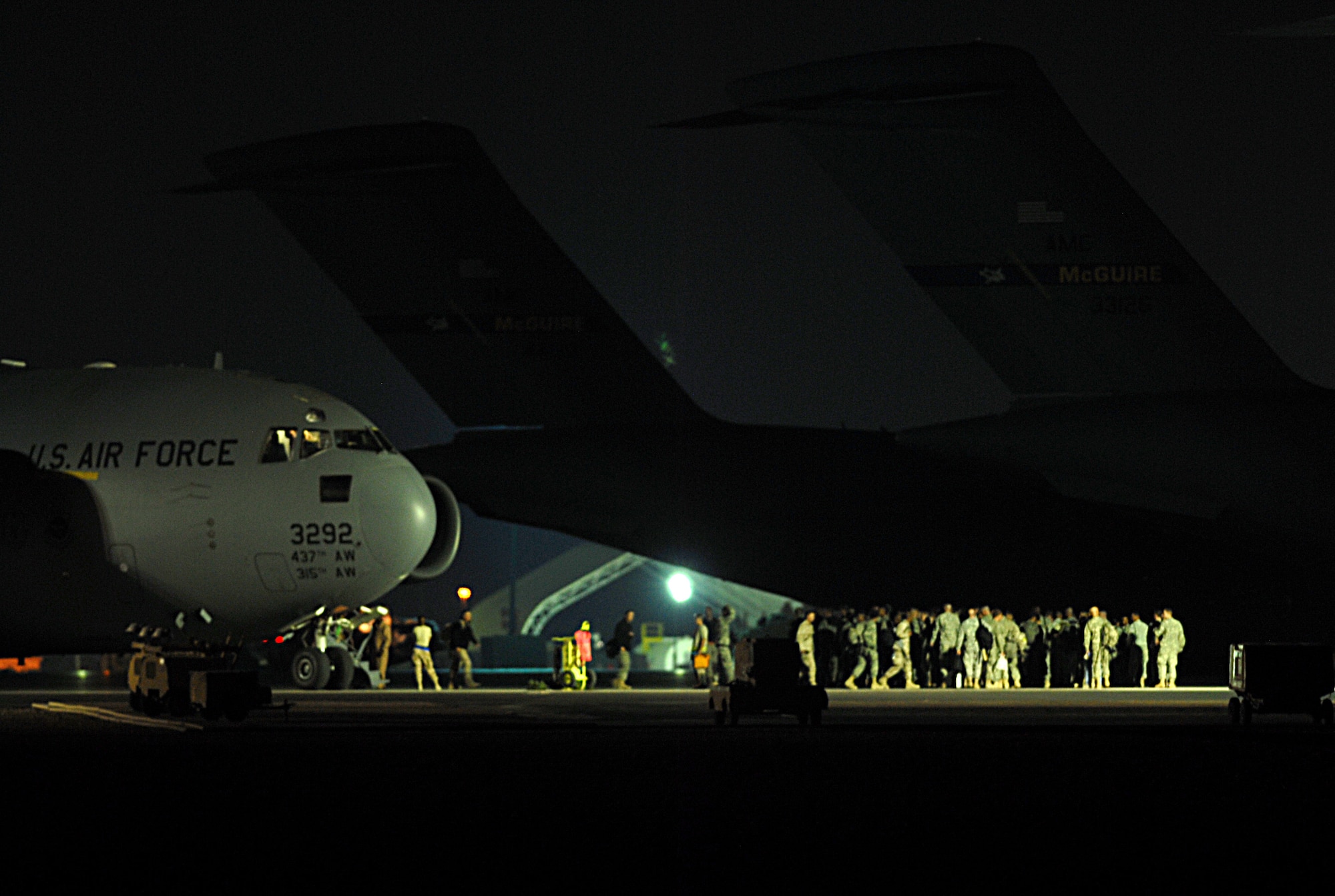 SOUTHWEST ASIA - Personnel from the 379th Expeditionary Aircraft Maintenance Squadron work on a C-17 Globemaster III by illumination from light carts Nov. 16 at a Southwest Asia air base.  (U. S. Air Force photo/Staff Sgt. Douglas Olsen)