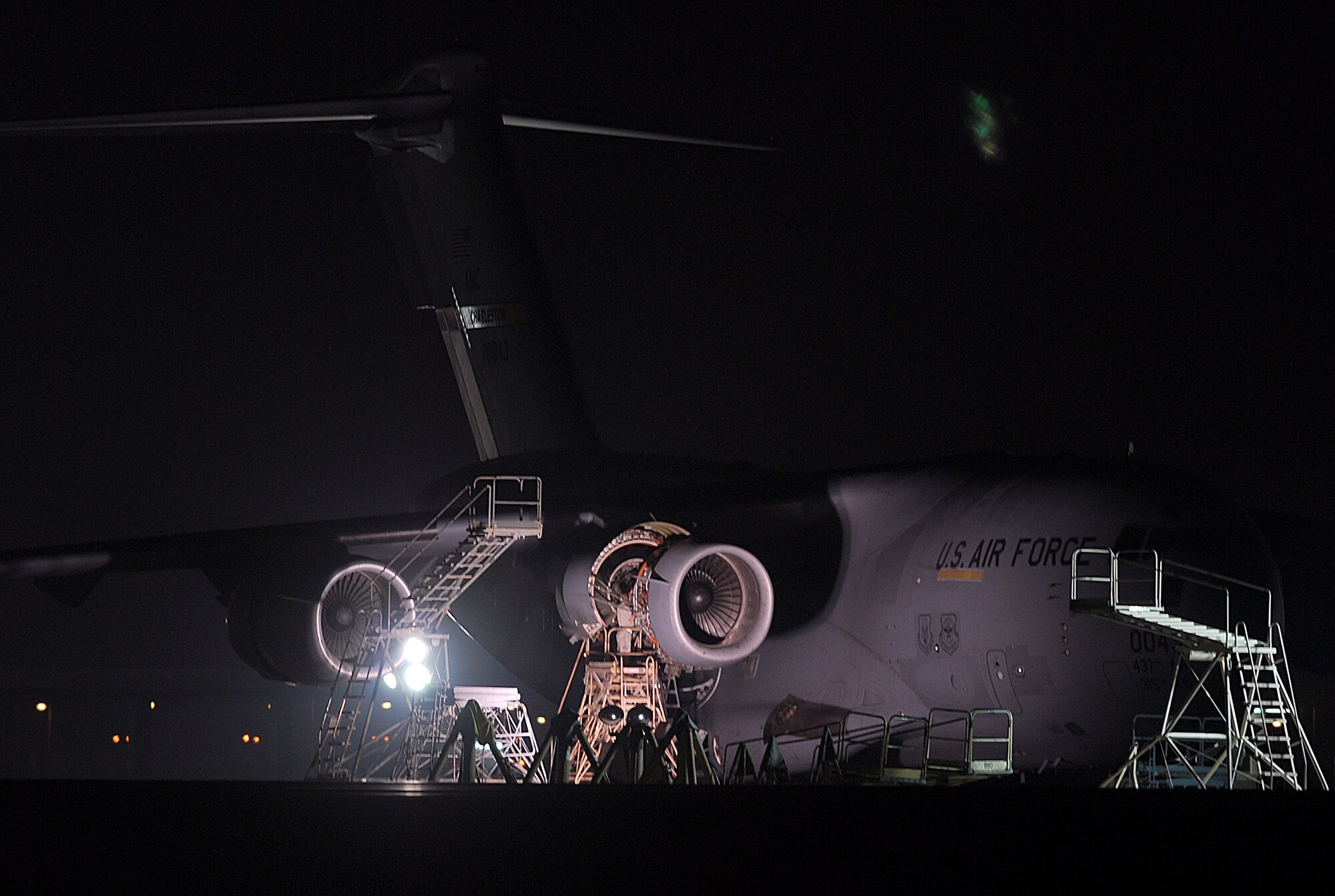 SOUTHWEST ASIA - Personnel from the 379th Expeditionary Aircraft Maintenance Squadron work on a C-17 Globemaster III by illumination from light carts Nov. 16 at a Southwest Asia air base.  (U. S. Air Force photo/Staff Sgt. Douglas Olsen)