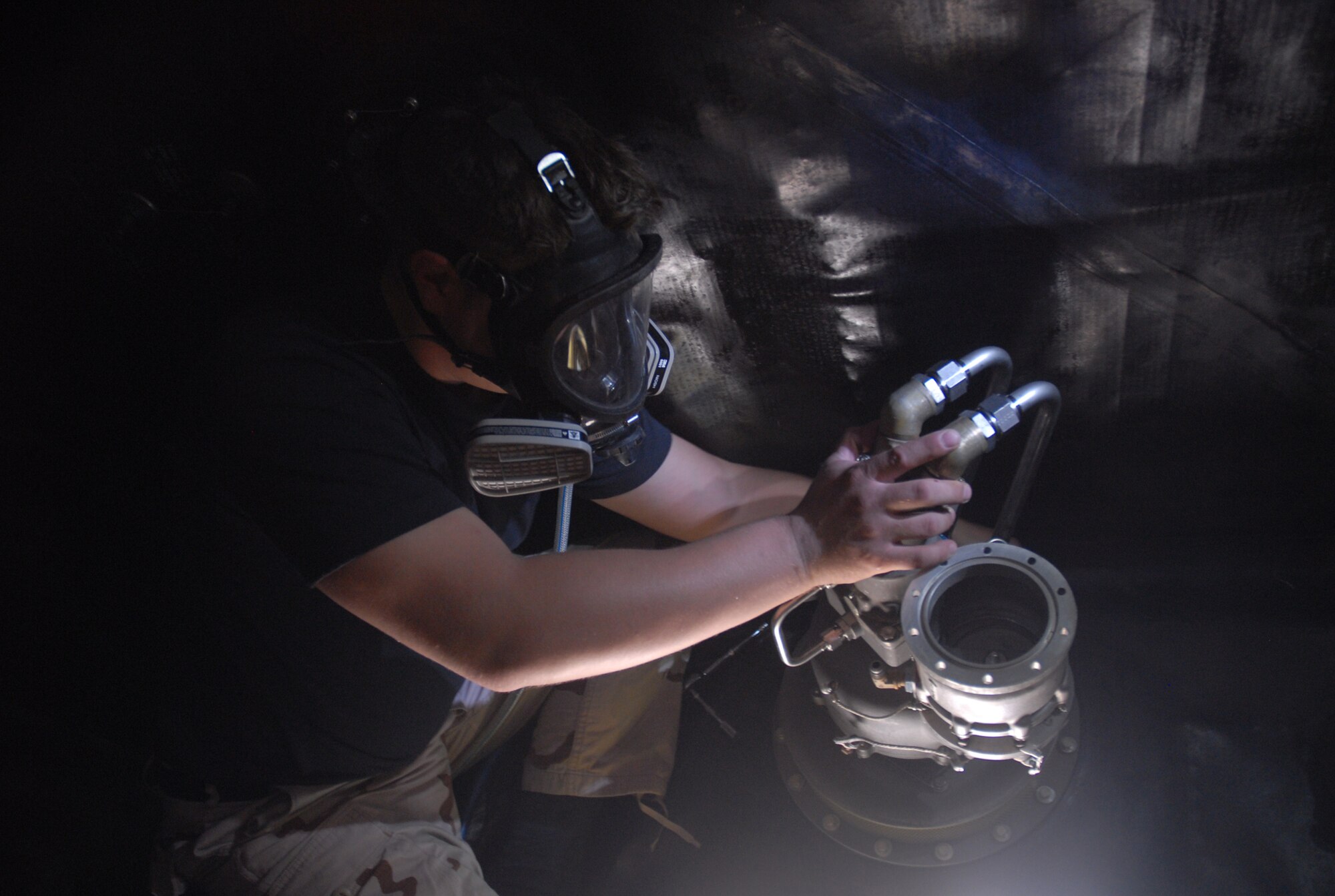SOUTHWEST ASIA - Airman 1st Class Shaun Carrig, 379th Expeditionary Aircraft Maintenance Squadron fuel systems journeyman, installs a for and aft air refueling pump in the #3 forward body fuel tank of a KC-135 Stratotanker Nov. 17 at a Southwest Asia air base. Airman Carrig is deployed from Grand Forks AFB, N.D., and his hometown is Cleveland, Ohio.(U. S. Air Force photo/Staff Sgt. Douglas Olsen)