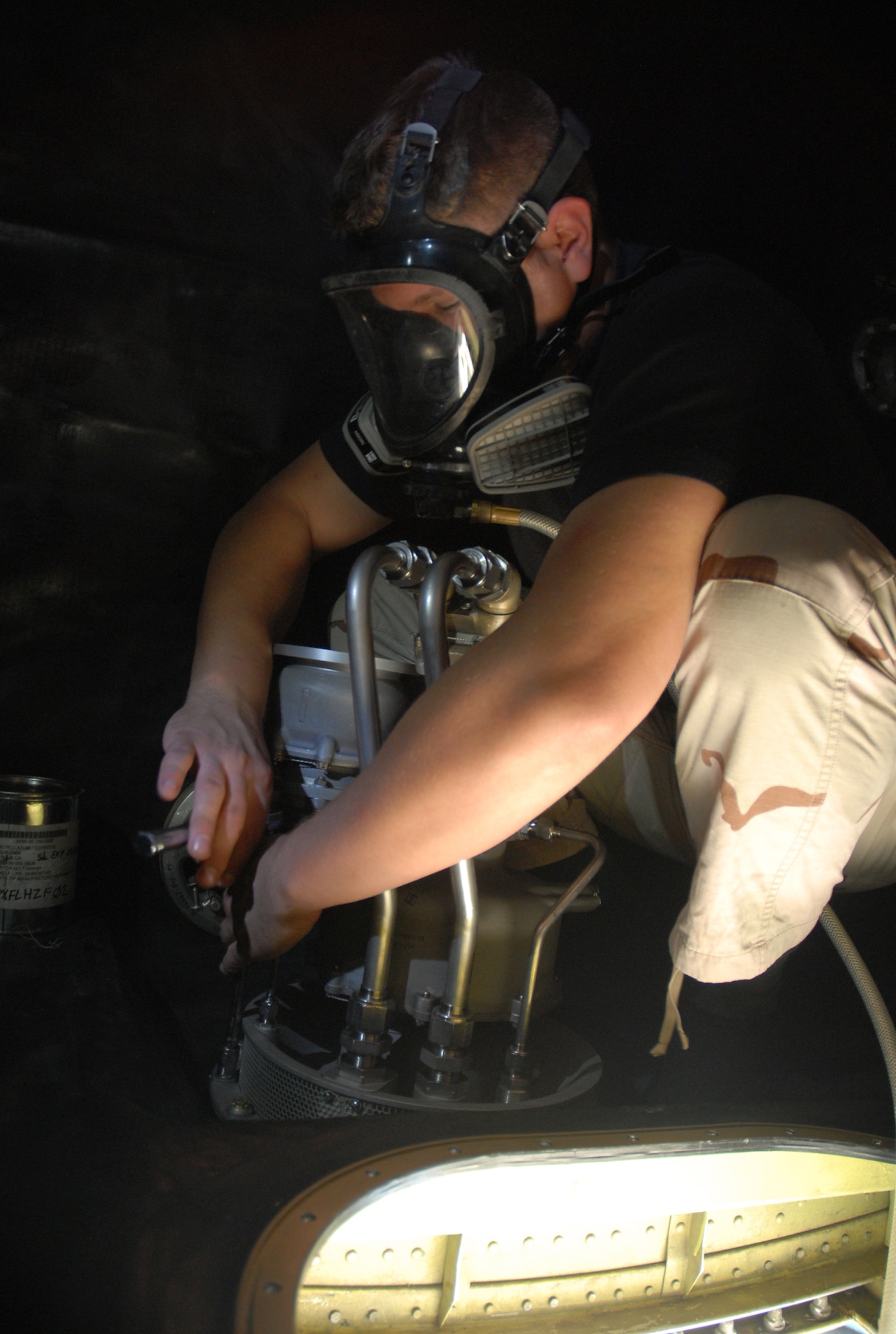 SOUTHWEST ASIA - Airman 1st Class Shaun Carrig, 379th Expeditionary Aircraft Maintenance Squadron fuel systems journeyman, installs a for and aft air refueling pump in the #3 forward body fuel tank of a KC-135 Stratotanker Nov. 17 at a Southwest Asia air base. Airman Carrig is deployed from Grand Forks AFB, N.D., and his hometown is Cleveland, Ohio. (U. S. Air Force photo/Staff Sgt. Douglas Olsen)