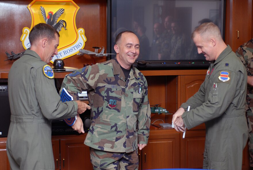 Brig. Gen. Brett T. Williams, 18th Wing commander, places a large chief master sergeant chevron on Senior Master Sgt. Dennis T. Smith, 18th Operations Support Squadron, Nov. 16, 2007, to wear until the Chiefs Icebreaker ceremony held the following day at Kadena Air Base, Japan.  By law only the top one percent of the enlisted corps are promoted to chief master sergeant.  Out of 2,476 eligible personnel this year, only 413 were selected Air Force wide.  (U.S. Air Force photo/Airman 1st Class Kelly Timney)