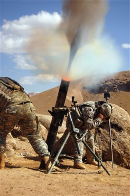 U.S. Army Pfc. Jerry Cleveland (left) and Spc. Brett Mitchell fire a 120mm mortar during combat operations in the Da'udzay Valley in the Zabol Province of Afghanistan on Oct. 23, 2007.  Cleveland and Mitchell are attached to Alpha Company, 1st Battalion, 4th Infantry International Security Assistance Force (ISAF).  The operation is a joint Afghan National Army and ISAF mission to clear anti-government elements from the Dawzi area in the Zabol province.  