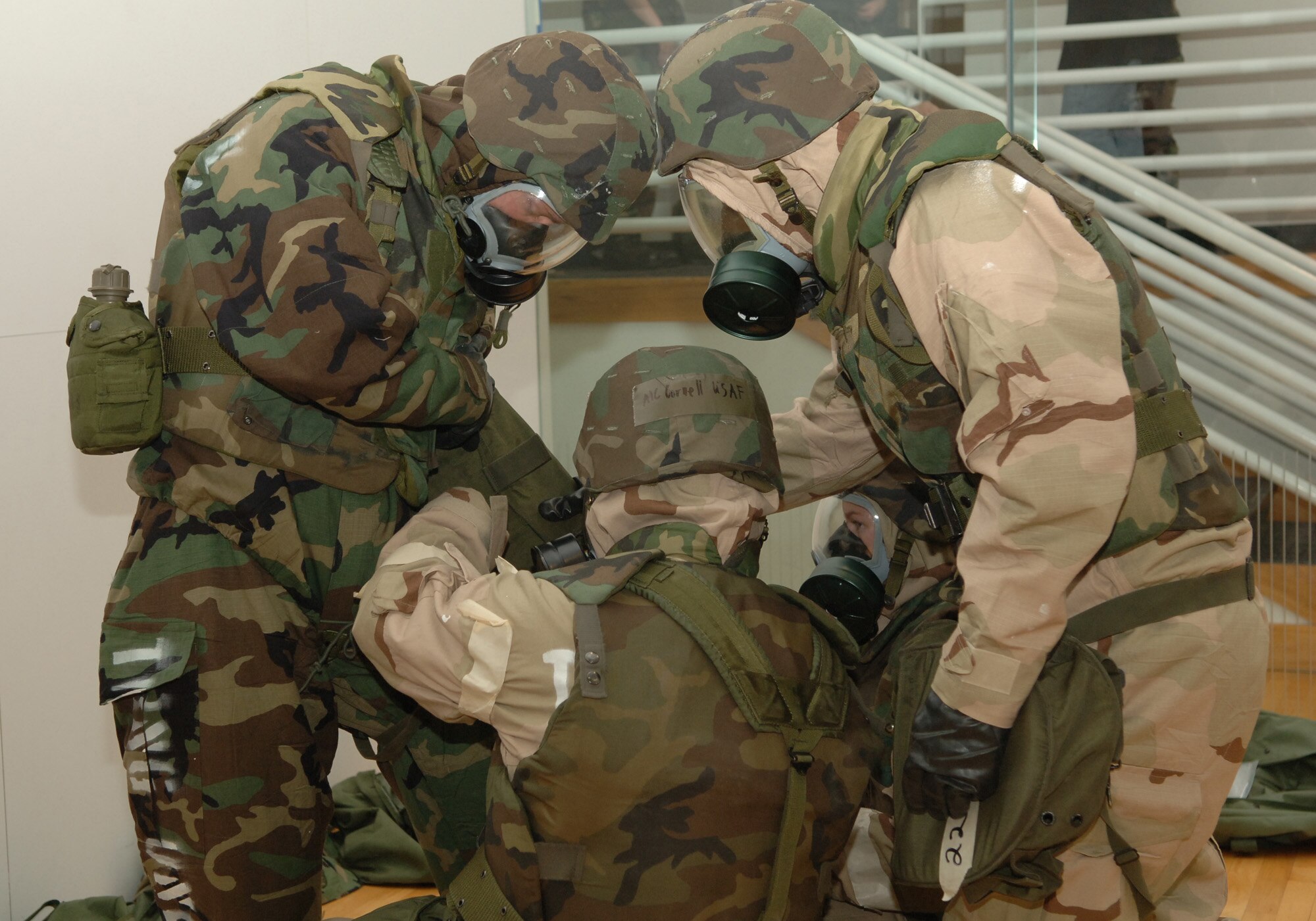 FAIRCHILD AIR FORCE BASE, Wash. – Senior Airman Seth McMillan, Airman 1st Class Lawrence Lee, Airman 1st Class Stephanie Welch, and Airman 1st Class Thomas Cornell, all of the 92nd Logistics Readiness Squadron check each other over after dawning their chemical gear during the 92nd Mission Support Group Expeditionary Combat Support Skills Competition Nov. 16.  The Expeditionary Combat Support Skills Competition was held from Nov. 13 – 16 and incorporated seven events ranging from Alaskan tent building to Self Aid Buddy Care. (U.S. Air Force photo by Airman 1st Class Jocelyn A. Ford)  