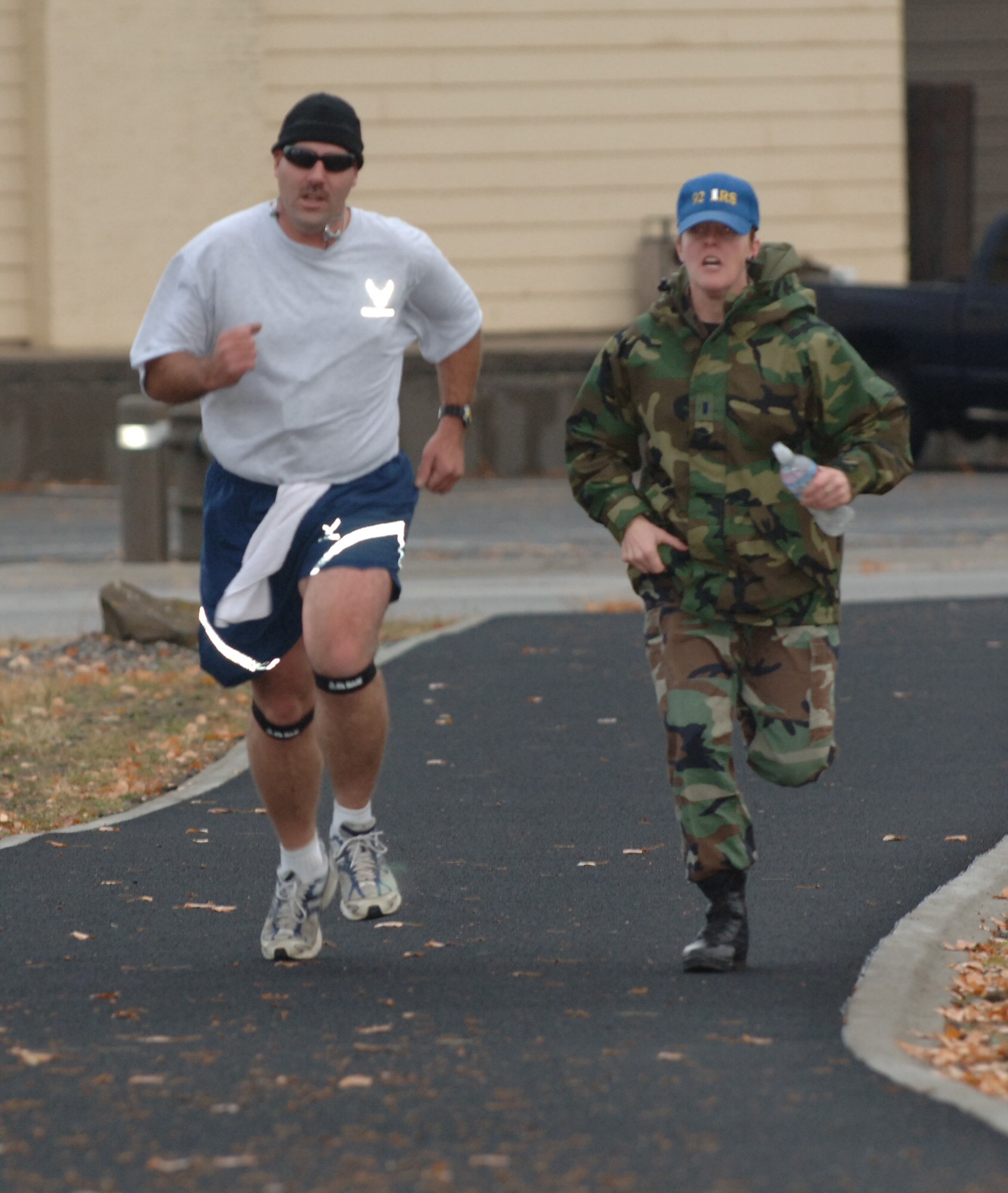 FAIRCHILD AIR FORCE BASE, Wash. – Tech. Sgt. Marc Avery of the 92nd Logistics Readiness Squadron runs the mile and a half while receiving motivation from 1st Lt. Jocelyn Nokes, 92nd Logistics Readiness Squadron, during the 92nd Mission Support Group Expeditionary Combat Support Skills Competition Nov. 16 at the outdoor running track. The Expeditionary Combat Support Skills Competition was held from Nov. 13 - 16 and incorporated seven events ranging from Alaskan tent building to Self Aid and Buddy Care. (U.S. Air Force photo by Airman 1st Class Jocelyn A. Ford)  