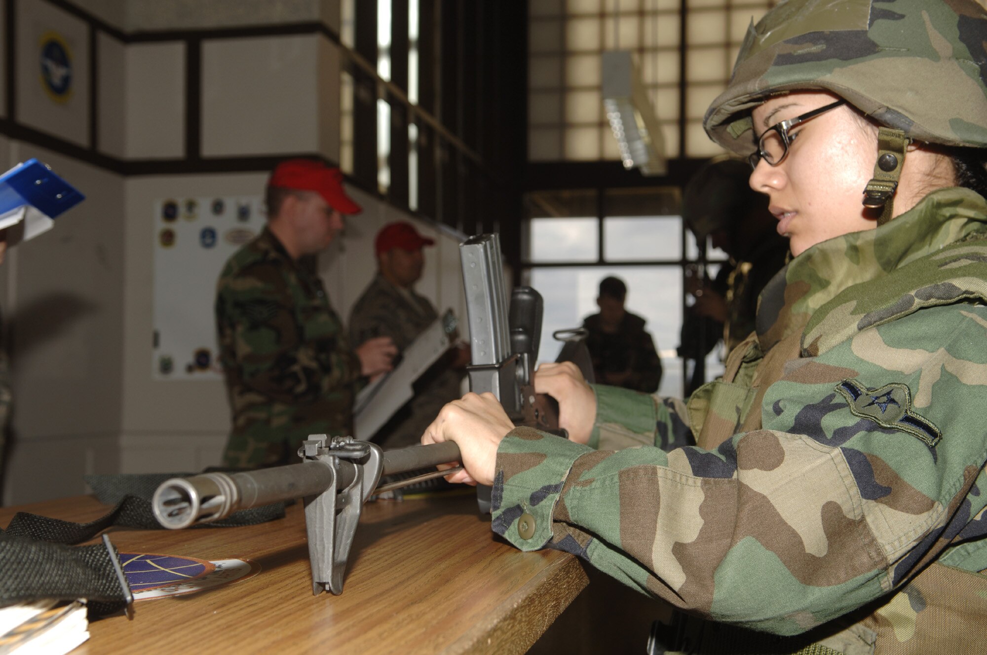 FAIRCHILD Air Force Base, Wash. – Airman Amy Perez, 92nd Services Squadron, assembles an M-16A2 shoulder fired, magazine fed, gas operated, air cooled, semi-automatic burst fired weapon during the weapon disassembly and assembly event at the 24-hour Fitness Center on Nov. 16 for the 92nd MSG’s Expeditionary Combat Support Skills Competition.  The Expeditionary Combat Support Skills Competition was held from Nov. 13 - 16h and incorporated seven events ranging from Alaskan tent building to Self Aid and Buddy Care.  (U.S. Air Force photo by Senior Airman Chad J. Watkins)