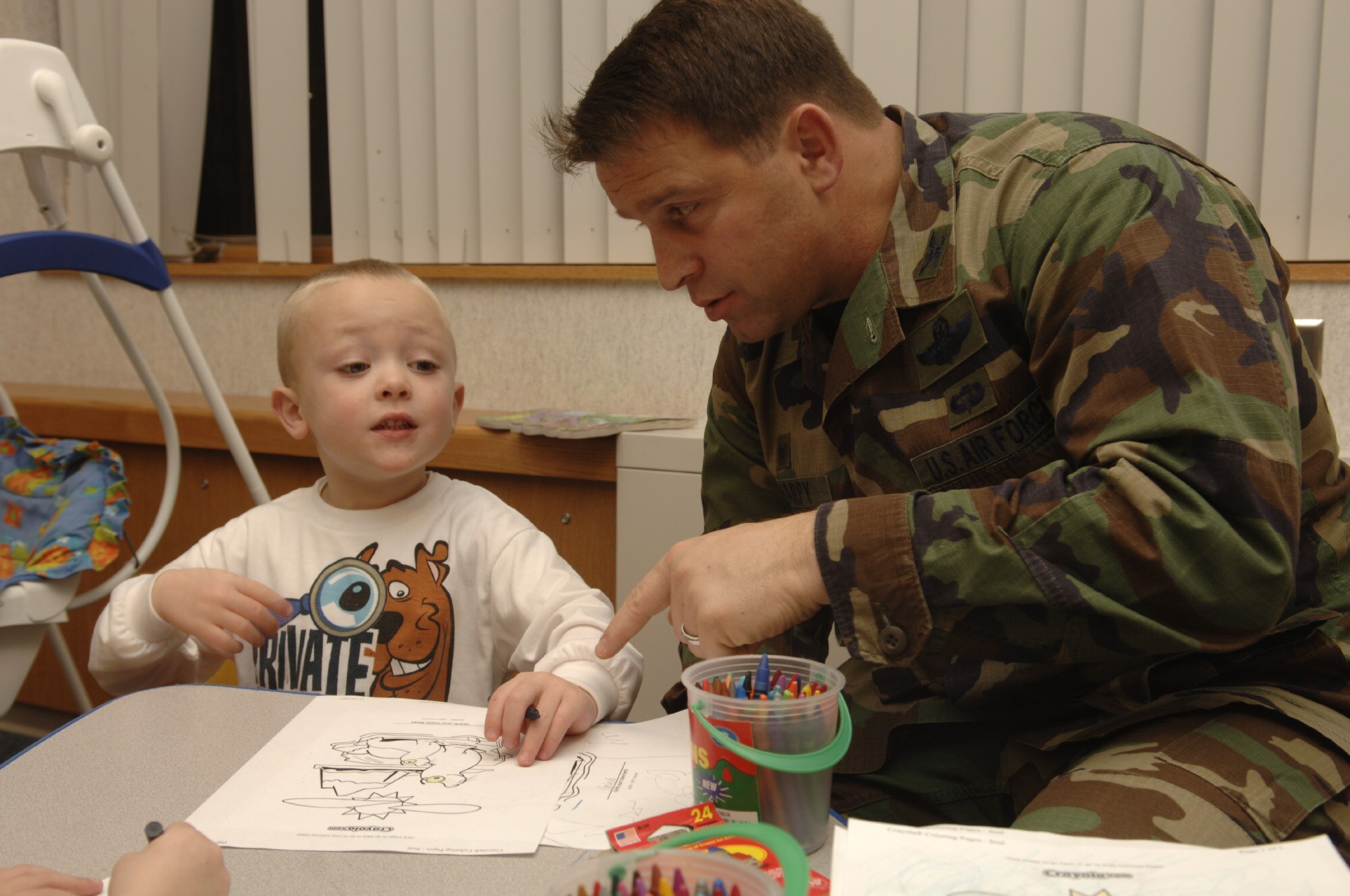FAIRCHILD AIR FORCE BASE, Wash. – Col. Thomas Sharpy, 92nd Air Refueling Wing commander, helps Caleb Degarmo color a picture on Nov. 16 during the Deployed Spouses Dinner held at the Fairchild Chapel. Caleb’s father, Staff Sgt. Justin Degarmo, 92nd Civil Engineer Squadron, is currently deployed in support of the Global War on Terrorism. (U.S. Air Force photo by Senior Airman Chad J. Watkins)