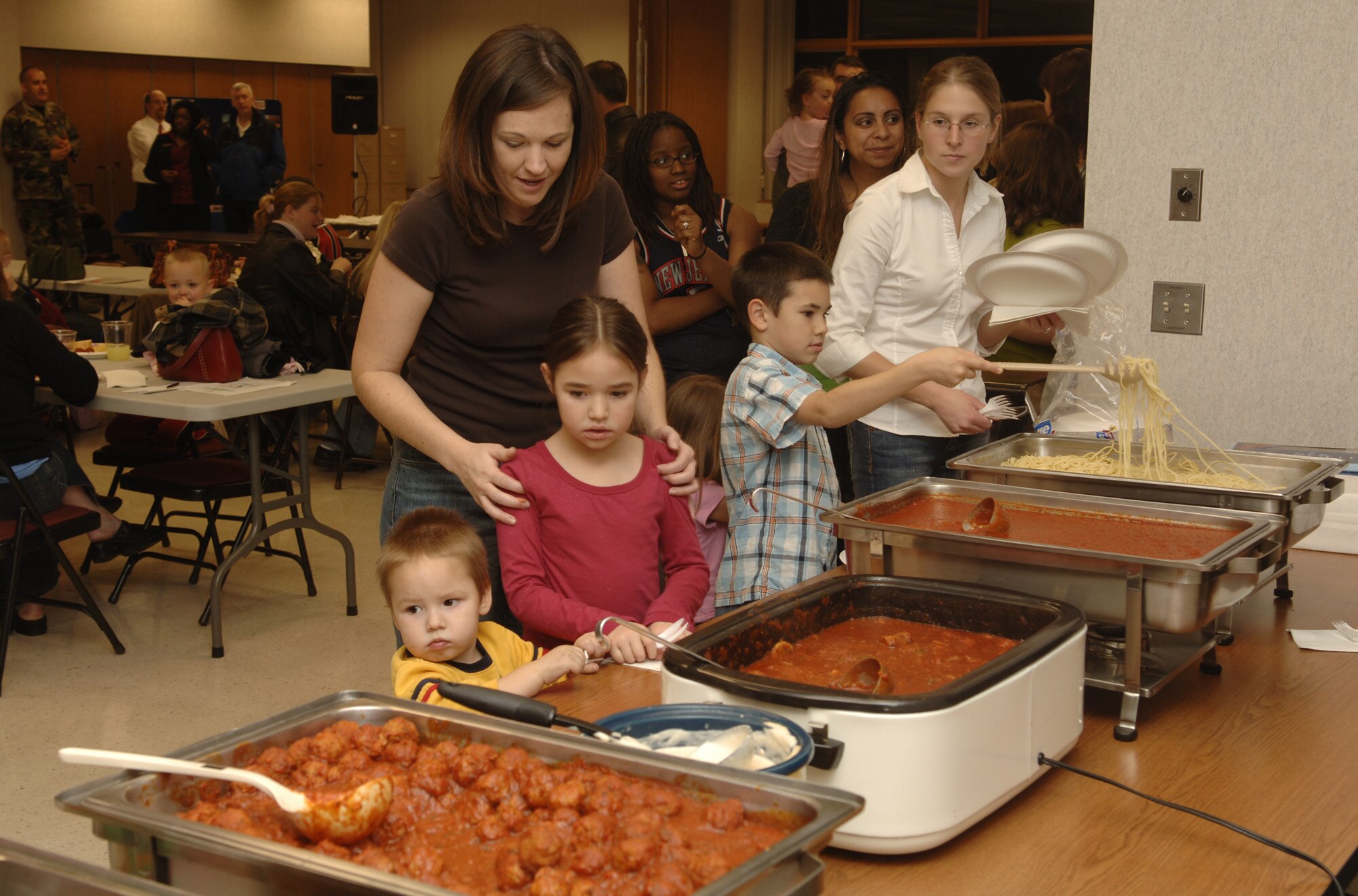 FAIRCHILD AIR FORCE BASE, Wash. – Family members of deployed Airmen fill their plates at the Deployed Spouses Dinner Nov. 16 at the base Chapel. The Italian- themed dinner provided the opportunity for spouses and children of deployed Airmen to come together with others who are in a similar situation, providing a network of support at Fairchild. (U.S. Air Force photo by Senior Airman Chad J. Watkins)
