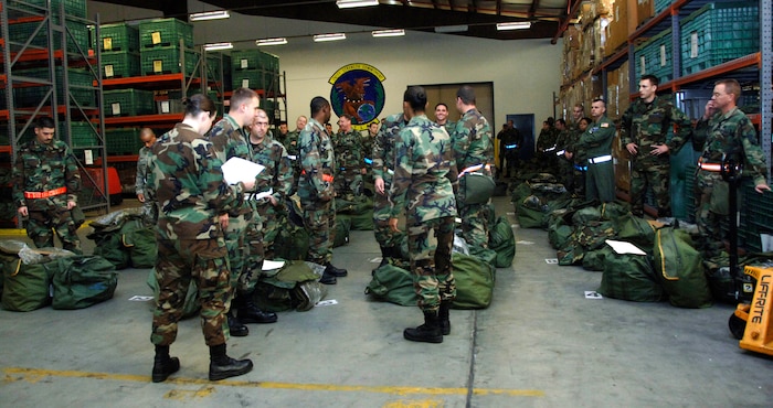 Team Charleston Airmen await further instructions while proceeding through the base mobility processing line Friday during the base mobility exercise. (U.S. Air Force photo/Airman 1st Class Katie Gieratz)