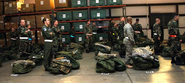 Team Charleston Airmen await instructions on what to do with their mobility equipment Friday during the base mobility exercise. (U.S. Air Force photo/Airman 1st Class Katie Gieratz)