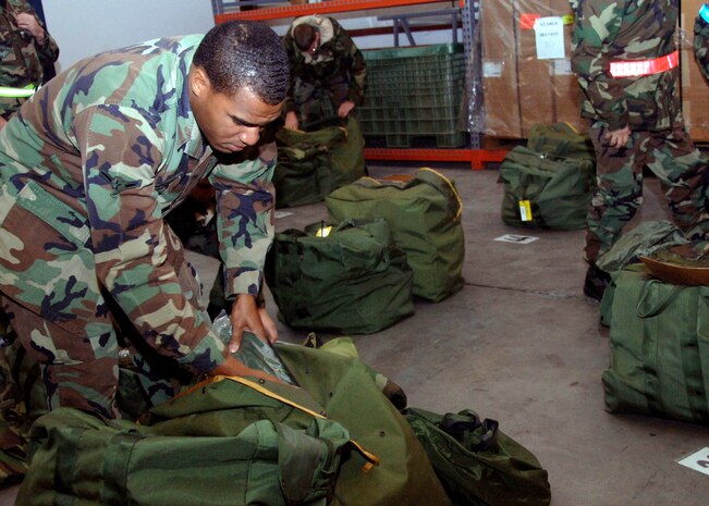 Airman Kyle Coverdale, 437th Maintenance Squadron, Aerospace Ground Equipment technican, inspects his bag to make sure he possesses all of the correct items during the base mobility exercise Friday. Team Charleston Airmen participated in a three-day exercise to determine the mobility readiness of units assigned to Charleston AFB in preparation for the upcoming Operational Readiness Inspection scheduled for August 2008. (U.S. Air Force photo/Airman 1st Class Katie Gieratz)