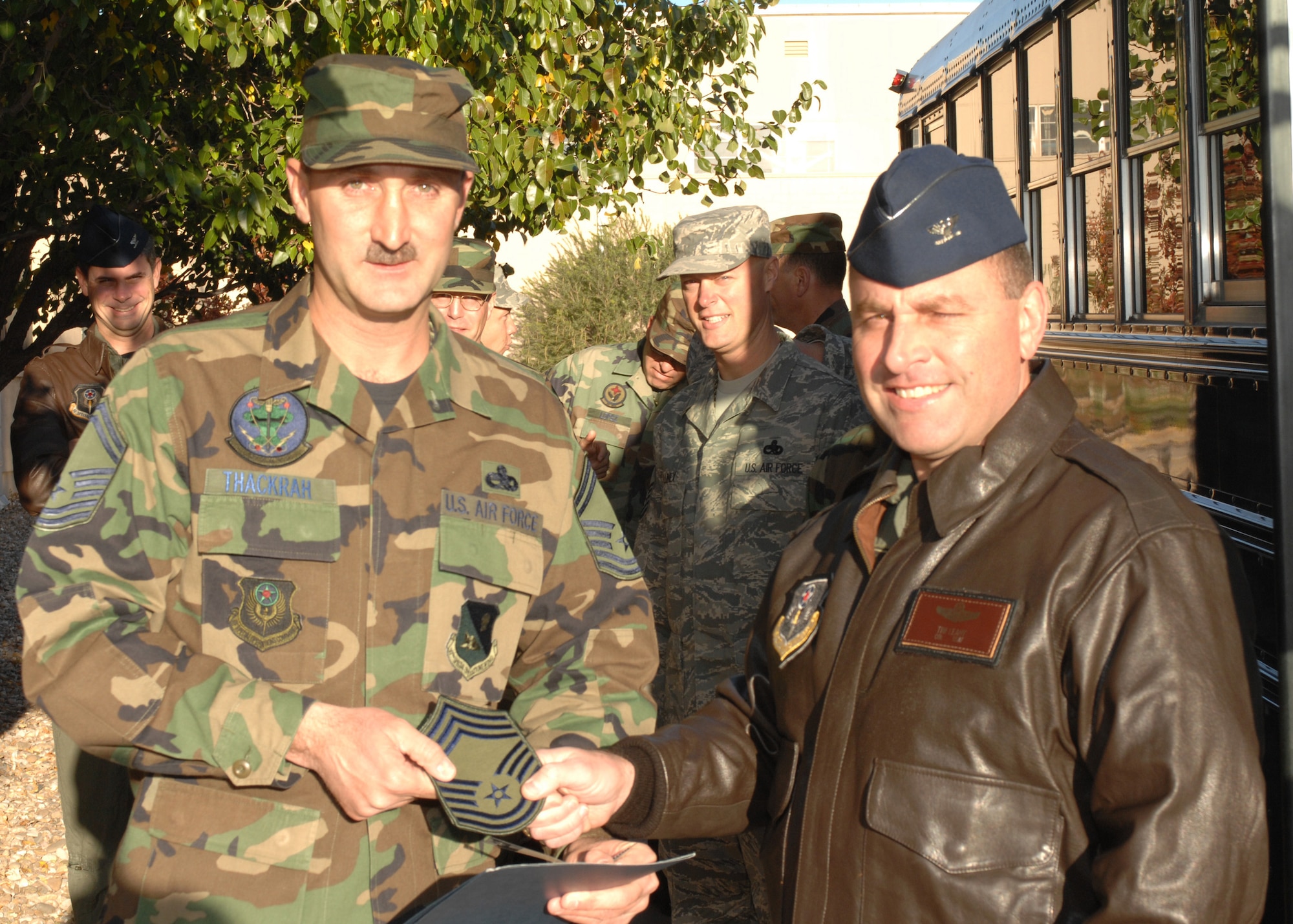 CANNON AIR FORCE BASE, N.M. -- Col. Timothy Leahy, 27th Special Operations Wing commander, congratulates Senior Master Sgt. Thomas Thakrah, 27th Special Operations Maintenance Squadron, on his selection for promotion to Chief Master Sgt. on Nov. 13. (Air Force photo by Staff Sgt. Richard Williams). 