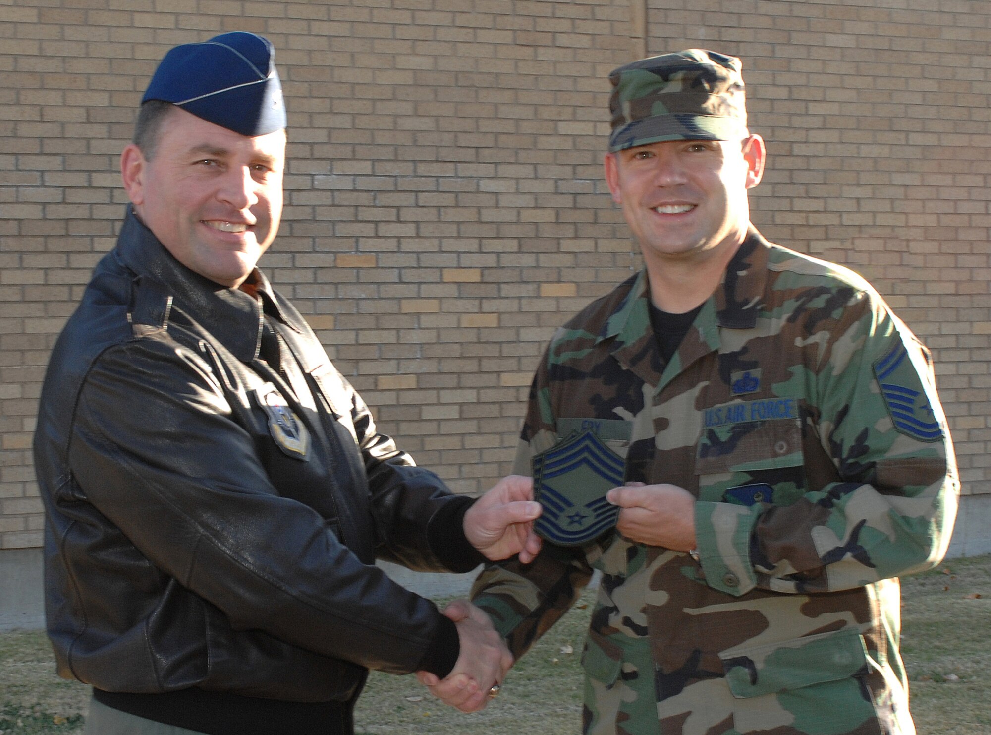 CANNON AIR FORCE BASE, N.M. -- Col. Timothy Leahy, 27th Special Operations Wing commander, congratulates Senior Master Sgt. Patrick Fry, 27th Special Operations Services Squadron, on his selection for promotion to Chief Master Sgt. on Nov. 13. (Air Force photo by Staff Sgt. Richard Williams)