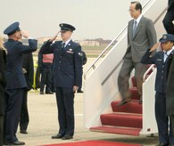 Col. Paul R. Ackerley, 316th Wing commander, salutes Yasuo Fukuda, 91st Prime Minister of Japan, as he deplanes his aircraft on the Andrews Air Force Base flight line Nov. 15. (US Air Force/SrA Laura Cirksena)