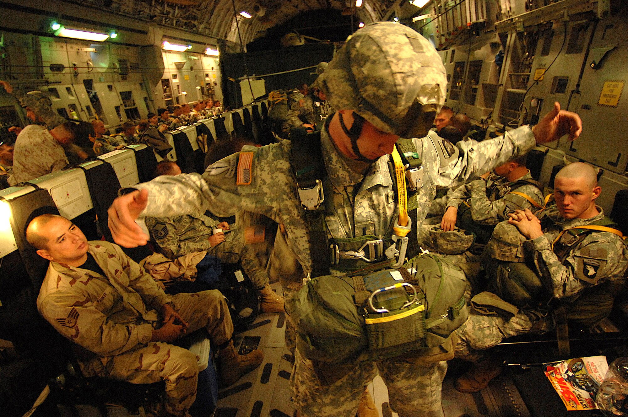U.S. Army paratroopers from the 20th Engineering Brigade, 101st Airborne Division, Fort Campbell, Ky., and Egyptian paratroopers prepare their chutes aboard a Charleston AFB C-17 aircraft for an air drop into Cairo, Egypt, Nov. 7 as part of exercise Bright Star 2007. (U.S Air Force photo/Staff Sgt. Aaron Allmon)