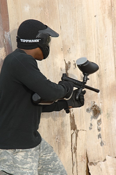 Staff Sgt. John Patton hides behind a wall, while looking for  his shot during a paintball tournament in the 4th Annual Dyess Olympics. His team, Delta Farce, place first in the competition. (U.S. Air Force photo by Airman Stephen Reyes)