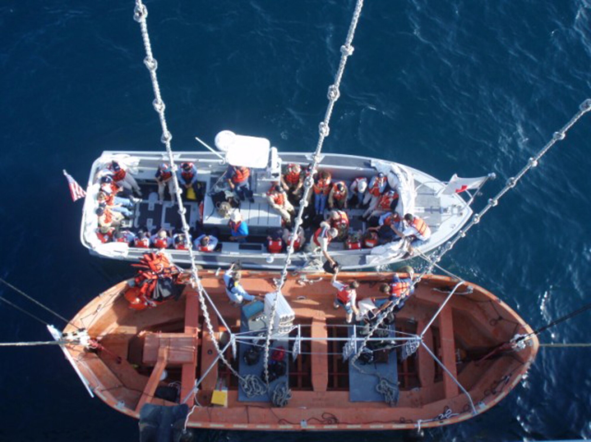 HAITI -- Medics with the Partnership of the Americas mission transfer from transport boat to life raft on their way back onto the USNS Comfort off the coast of Port Au Prince, Haiti, in September. The life boat was raised and lowered along the side of the Comfort, and was the only way for medics to board and exit the Comfort by sea.  (U.S. Air Force photo/Tech. Sgt. Jason Conely)