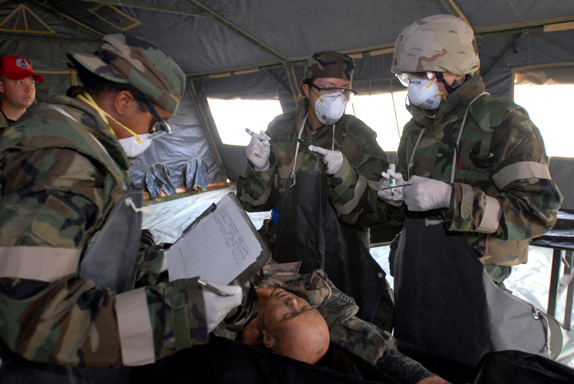 Airman 1st Class Connecticut Wilson (left), Staff Sgt. Joanne Richards and Airman 1st Class Darrin Wagner, 36th Services Squadron, process a simulated deceased person's information for the mortuary affairs portion of an exercise at Kadena Air Base, Japan, Nov. 16. Approximately 110 personnel, most from Andersen Air Force Base, Guam, attended the Det. 1, 554th Rapid Engineer Deployable Heavy Operational Repair Squadron Engineer Silver Flag exercise here. (U.S. Air Force photo/Senior Airman Darnell T. Cannady) 
