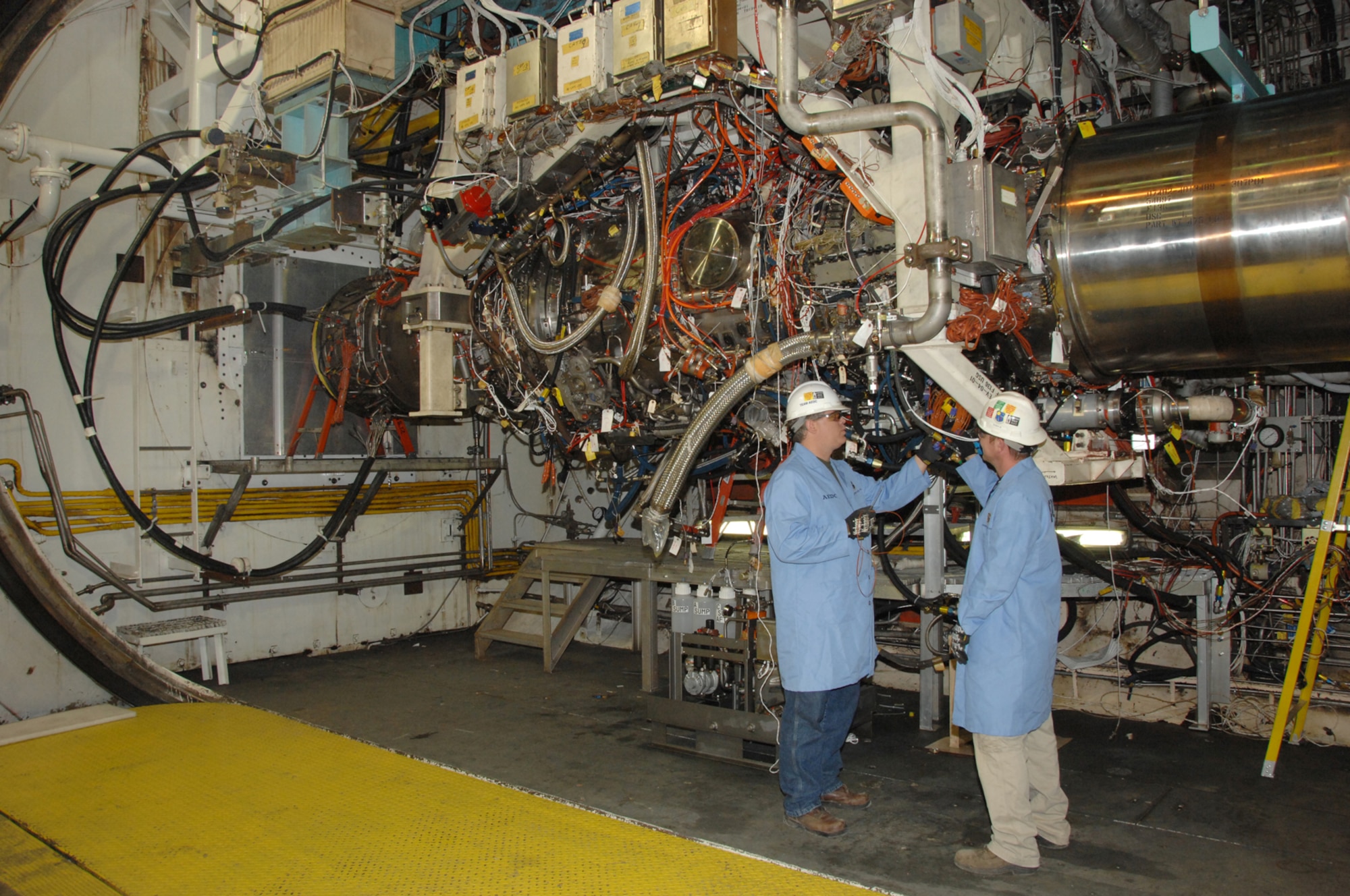 From left, Russell Montandon, Aerospace Testing Alliance (ATA) outside machinist and ATA Boilermaker Nathan Tippy, inspect the GE/Rolls-Royce F136 engine in Arnold Engineering Development Center’s (AEDC) Test Cell J-2 during a break in testing. (Photo by David Housch)