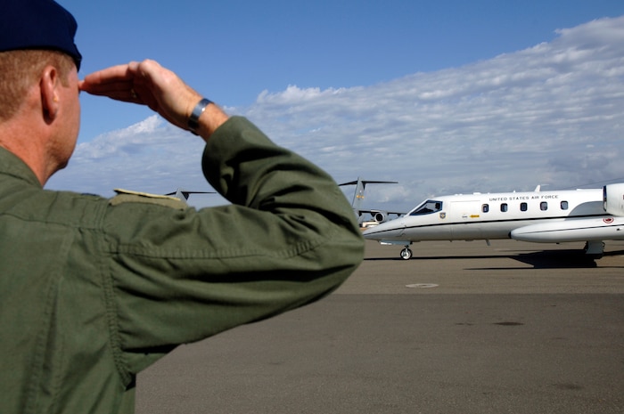 Col. John "Red" Millander, 437th Airlift Wing commander, gives a final salute to General Hawkins, 18th Air Force commander, as his plane takes off from Charleston AFB Nov. 15.  (U.S. Air Force photo/Staff Sgt. April Quintanilla) 